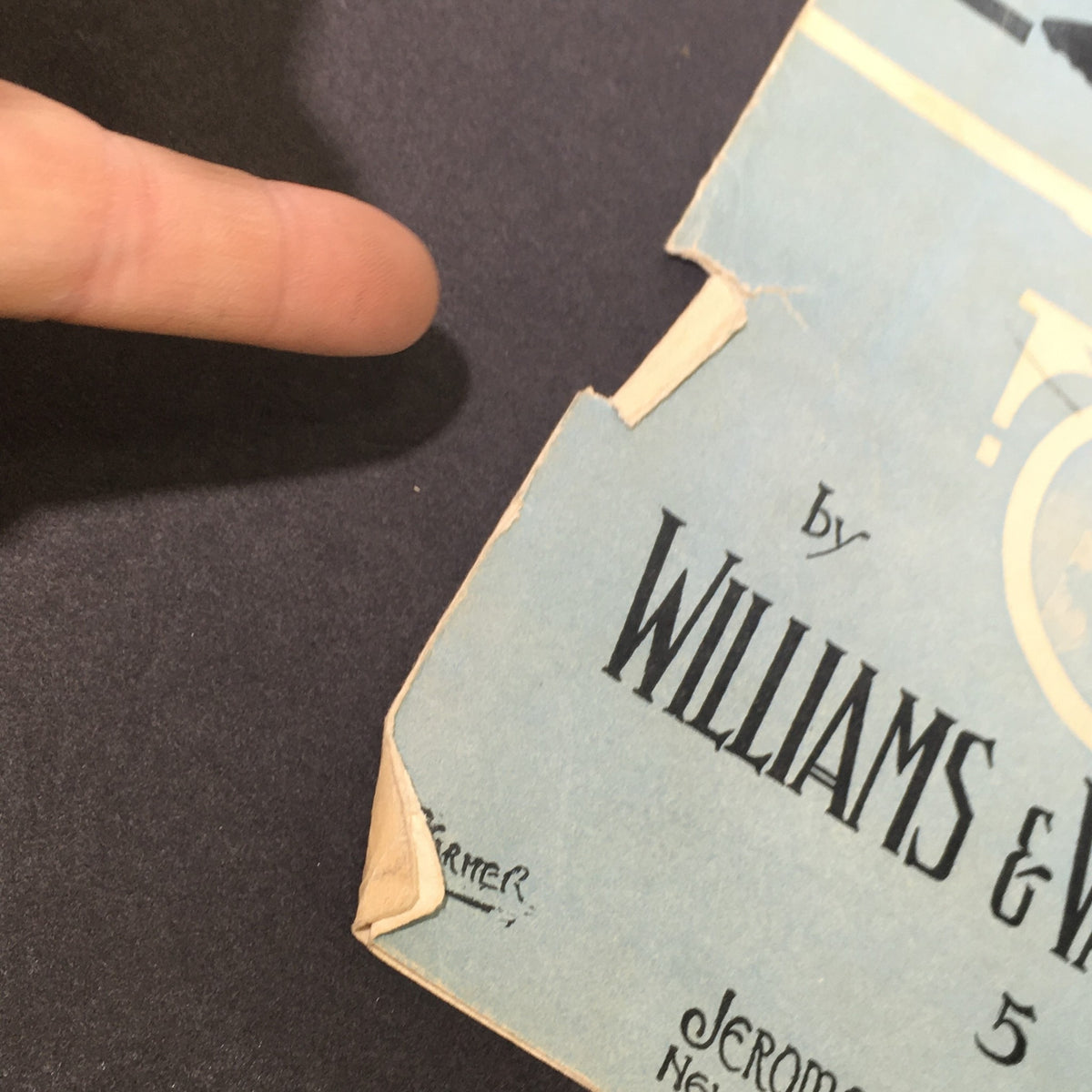 Close-up of the edge of the vintage sheet music for 'What's The Matter With Father', highlighting details and minor wear.