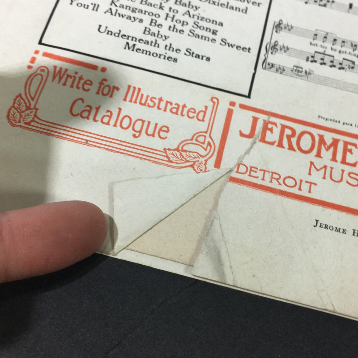 Close-up of the edge of the Pretty Baby song sheet, highlighting a small tear and details from the Jerome H. Remick advertisement.