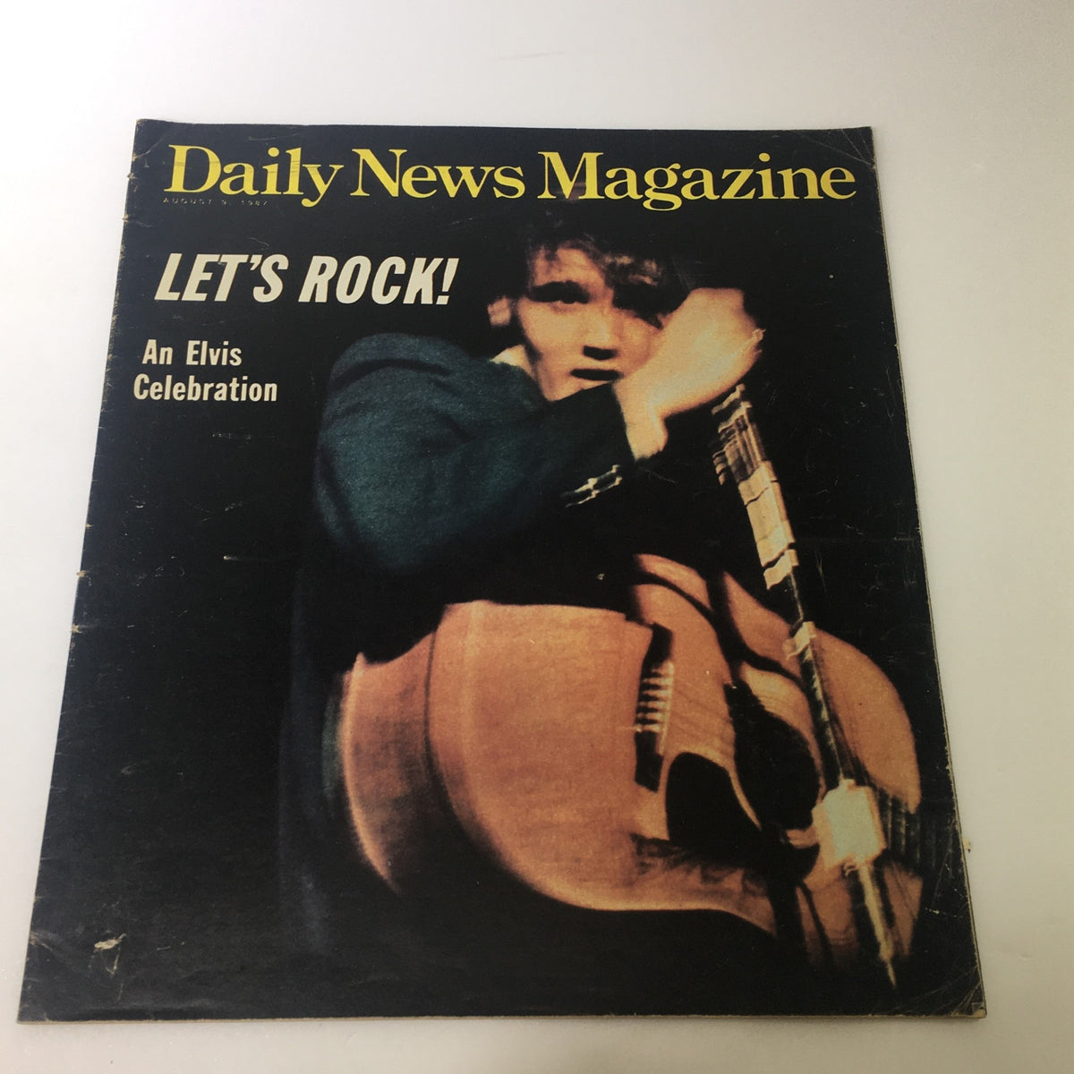Vintage Daily News Magazine from August 9, 1987, featuring Elvis Presley on the cover with the title 'LET'S ROCK! An Elvis Celebration.' This collectible item showcases the iconic musician.
