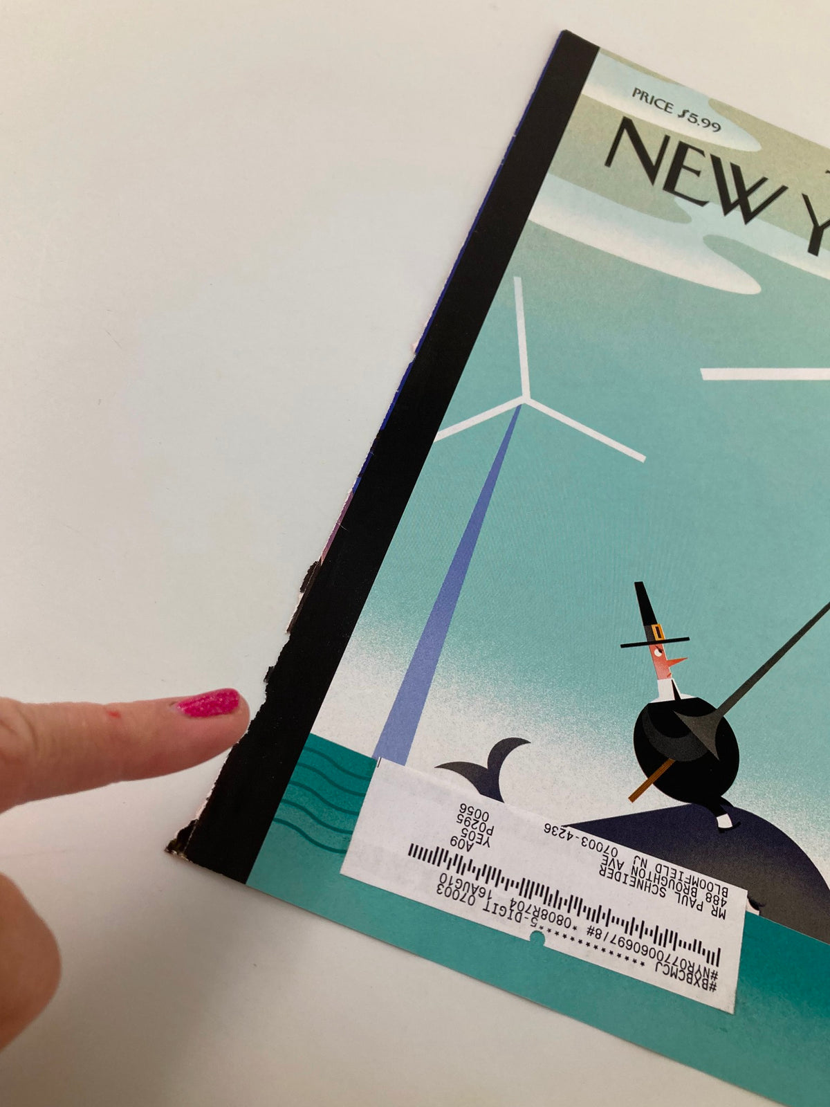 Close-up view of the spine and edge of The New Yorker May 10, 2010 cover titled 'Tilt' by Bob Staake, highlighting minor wear and a visible label for authenticity.