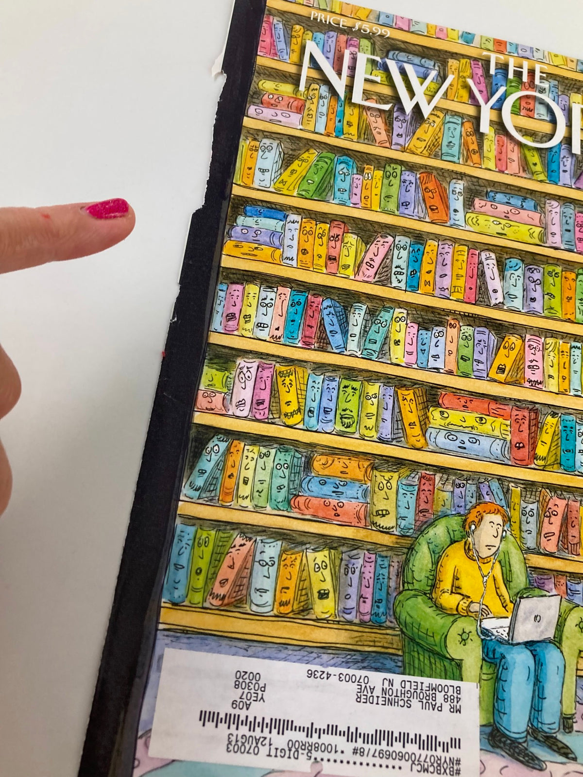 Side view of The New Yorker October 18 2010 cover by Roz Chast, highlighting the colorful bookshelves and detail of the page binding.