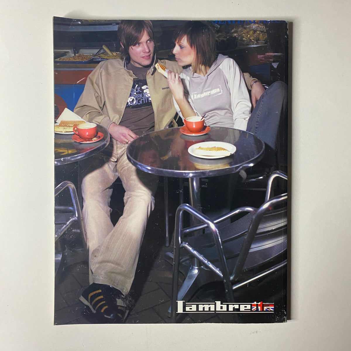 Back cover of NME Originals Magazine Vol 1 Issue 12 Uncut Presents The Who showing a modern scene with two individuals at a café, emphasizing the magazine's cultural influence.