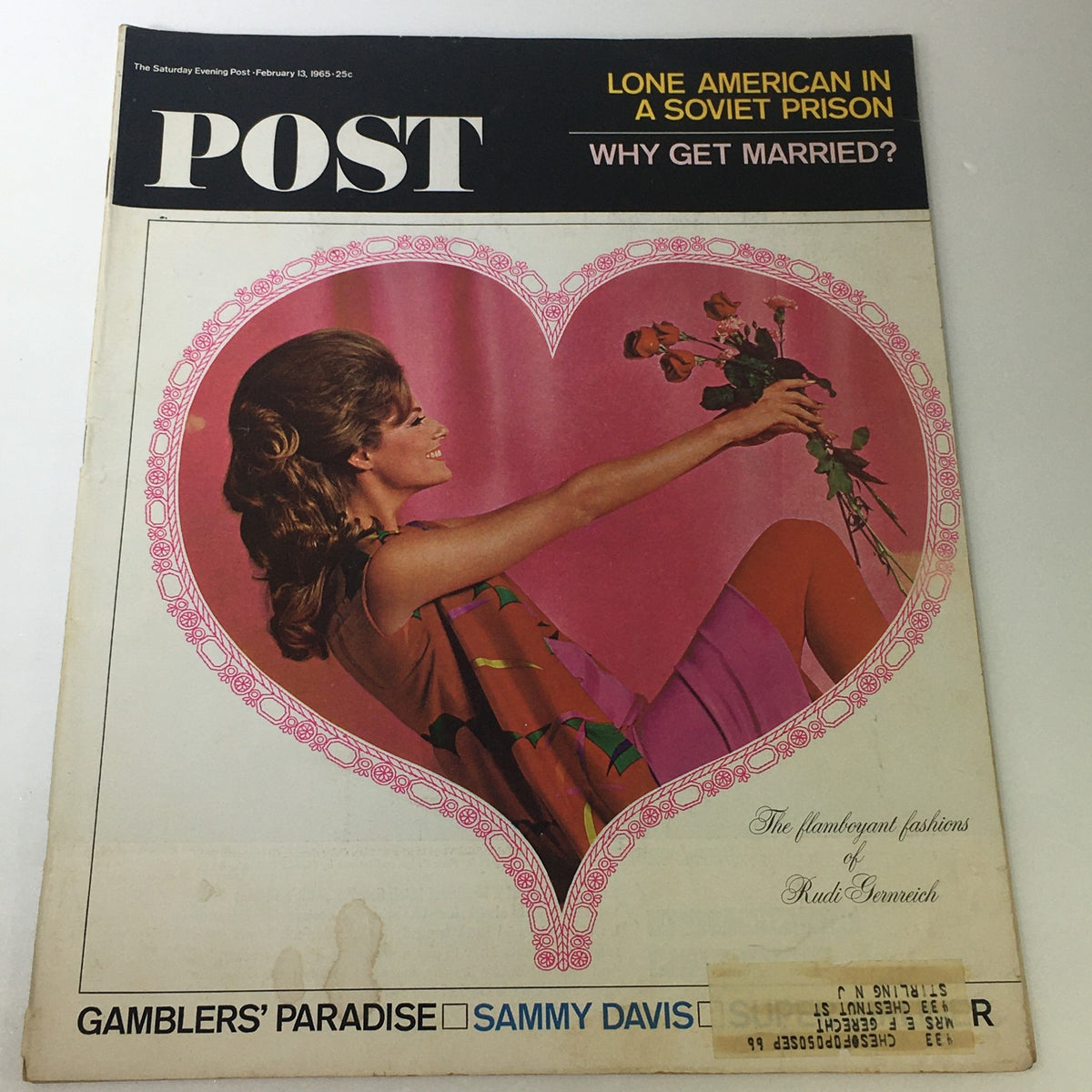 Cover image of The Saturday Evening Post dated February 13, 1965, featuring flamboyant fashions by Rudi Gernreich and an article about Sammy Davis Jr. The cover includes a heart shape design and a photograph of a model.