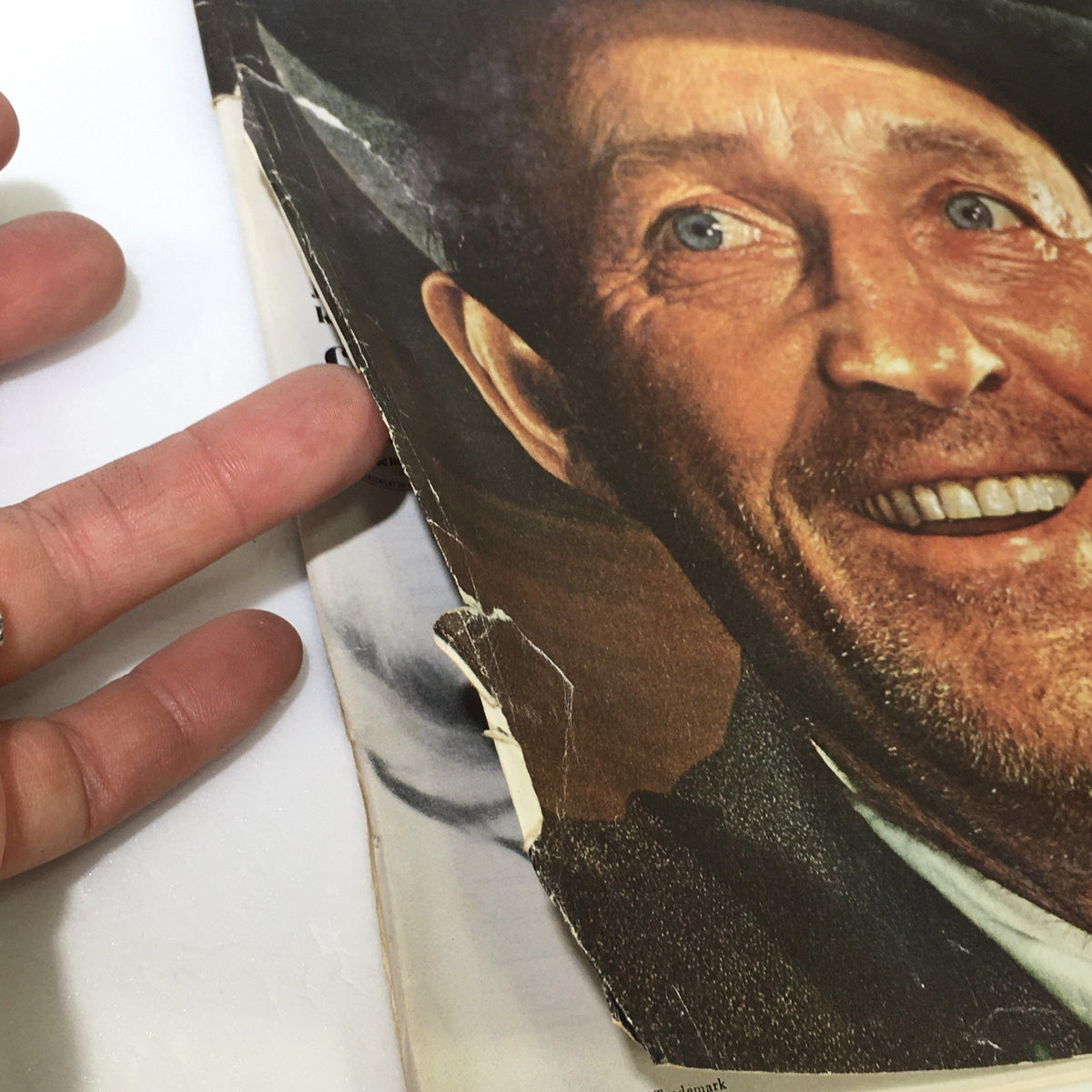 Close-up detail of the edge of VTG The Saturday Evening Post April 9 1966 magazine featuring Bing Crosby, showing wear and tear on the cover.