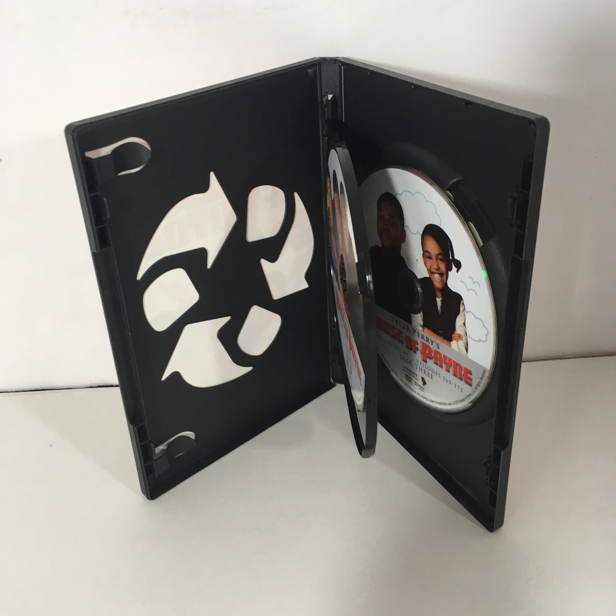 Inside view of Tyler Perry's House of Payne, Vol. 8 DVD case with a CD visible, highlighting the disc artwork and reusable disc holder.