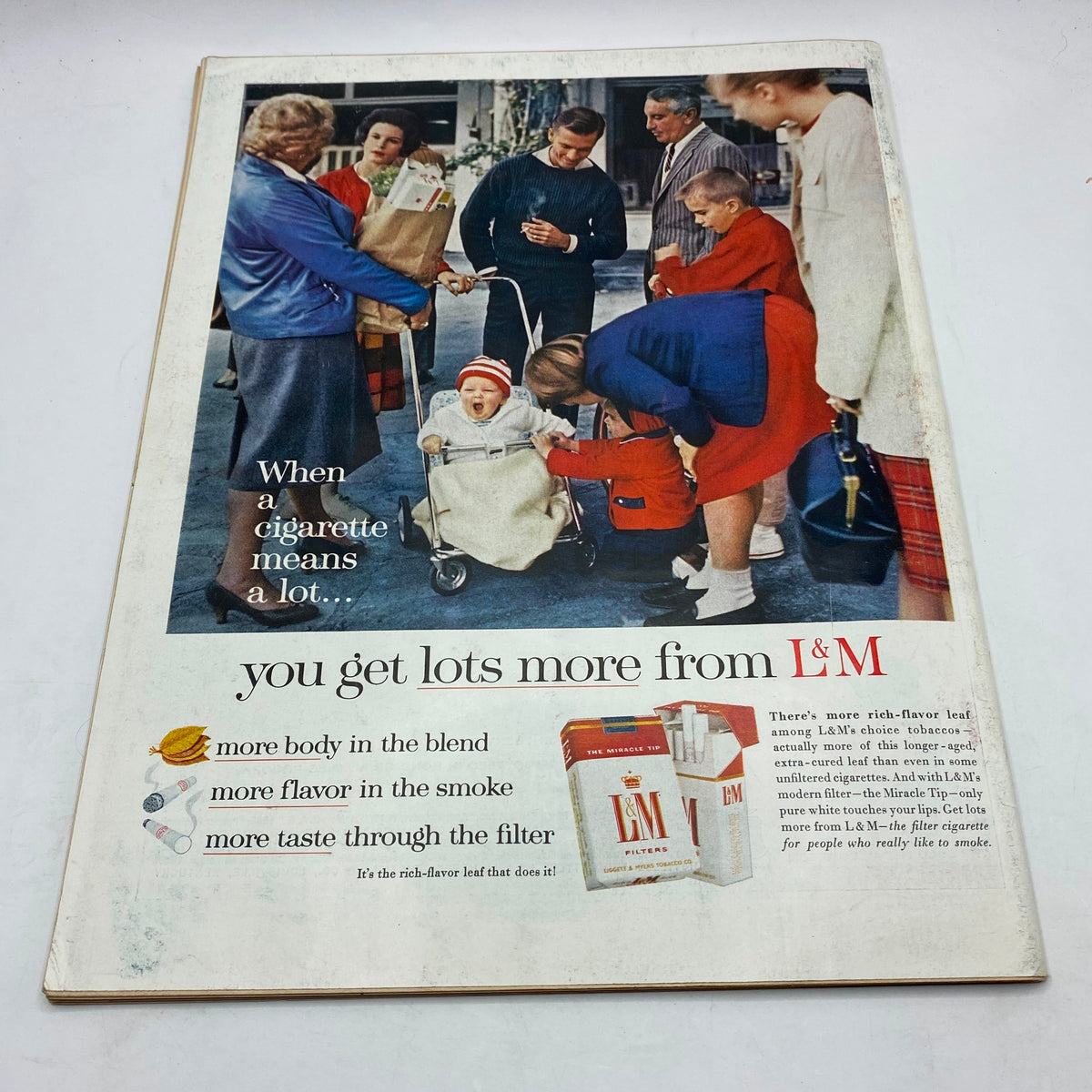 Life Magazine April 13, 1962 featuring an advertisement for L&M cigarettes showcasing a family scene with people interacting. The ad emphasizes the benefits of L&M cigarettes with the tagline about getting more from the blend, accompanied by a vibrant image of a baby in a stroller, people in stylish 1960s clothing, and cigarette pack display.