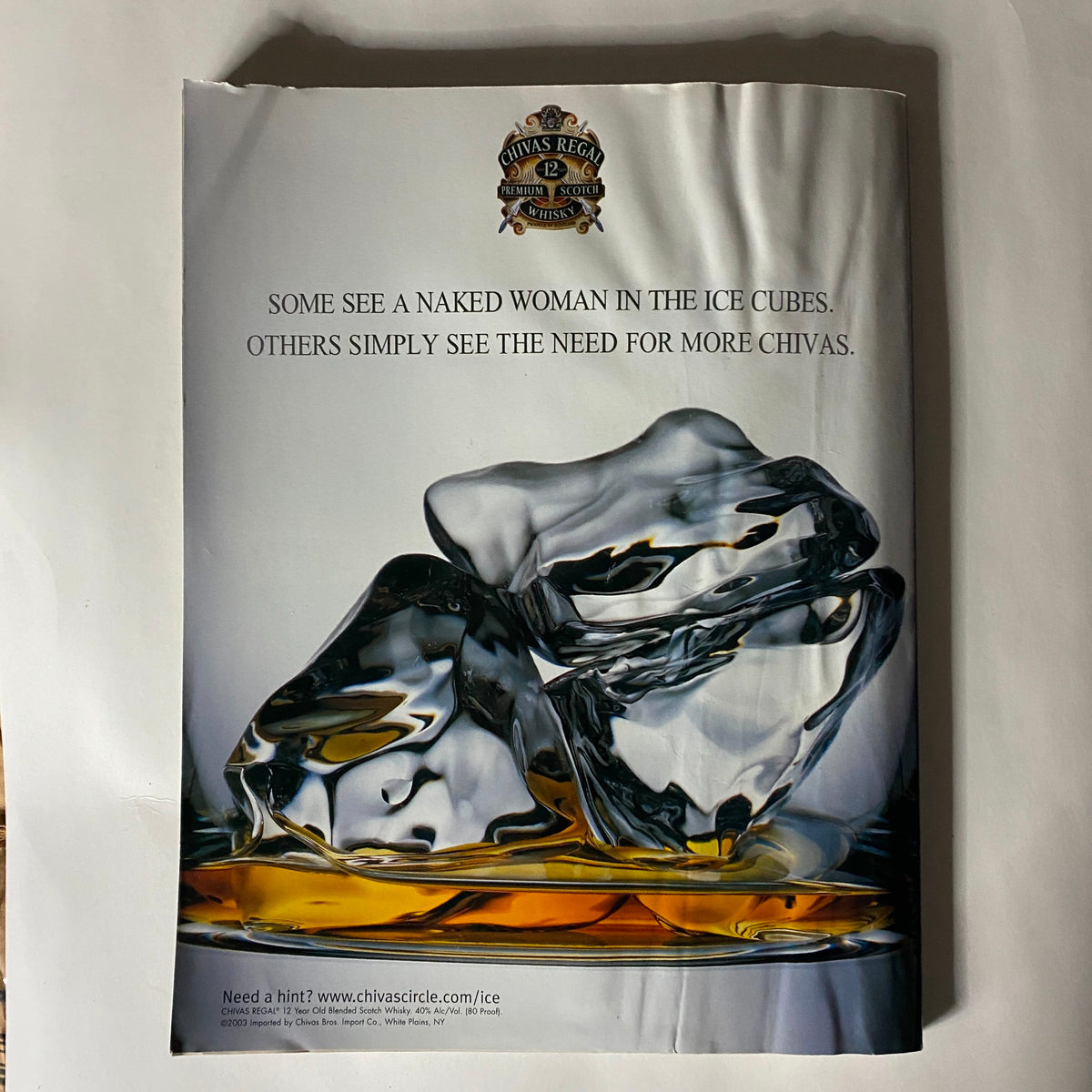 Advertisement from Sports Illustrated Magazine Winter 2003 featuring an artistic ice cube design with a slogan about Chivas, complementing the magazine's themes of luxury and lifestyle.