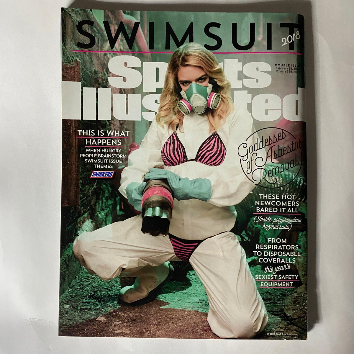 Sports Illustrated Magazine 2018 cover featuring a model in a gas mask and swimwear, creatively blending themes of sports and environmental awareness.
