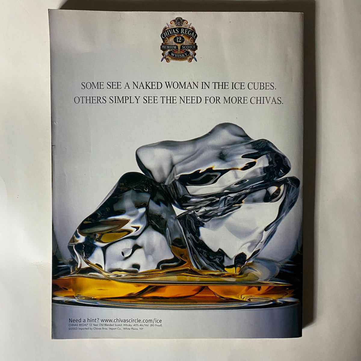 Advertisement from Sports Illustrated Magazine Winter 2003 depicting ice cubes with a provocative message, themed around Chivas Regal, creating a captivating visual play.