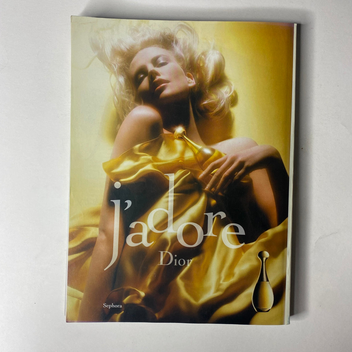 Dior fragrance advertisement from Vogue Magazine October 2004, showcasing J'adore in a glamorous, golden-themed layout with a model.
