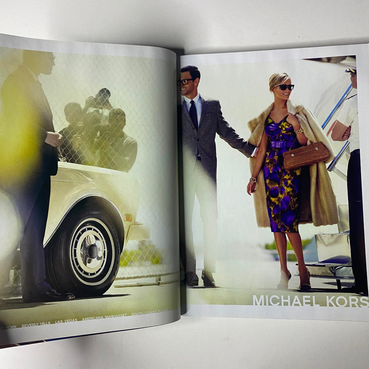Spread featuring a stylish couple next to a vintage car, highlighting a Michael Kors fashion advertisement from Vogue Magazine August 2008.