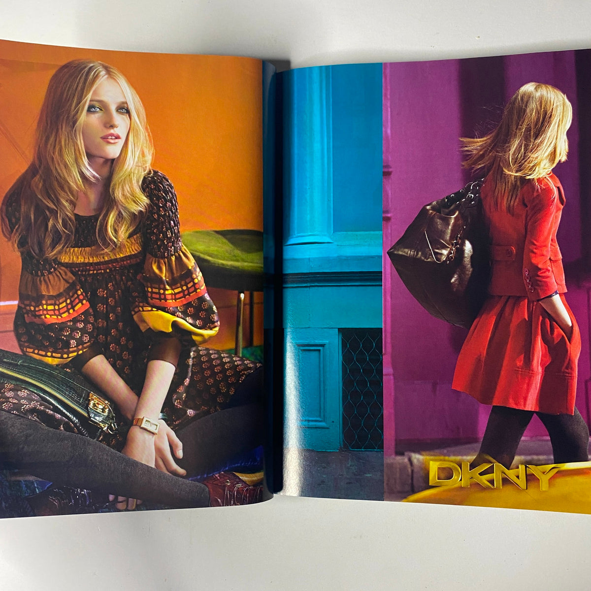 Vogue Magazine August 2008 advertisement showcasing a chic DKNY fashion spread with models displaying vibrant outfits against bold backgrounds.