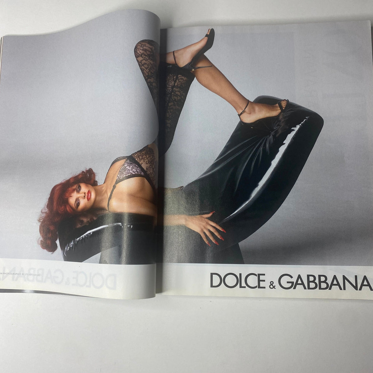 Image from Vogue Magazine September 2023 showcasing a model in a striking pose for Dolce & Gabbana, reflecting the era's bold fashion aesthetic.