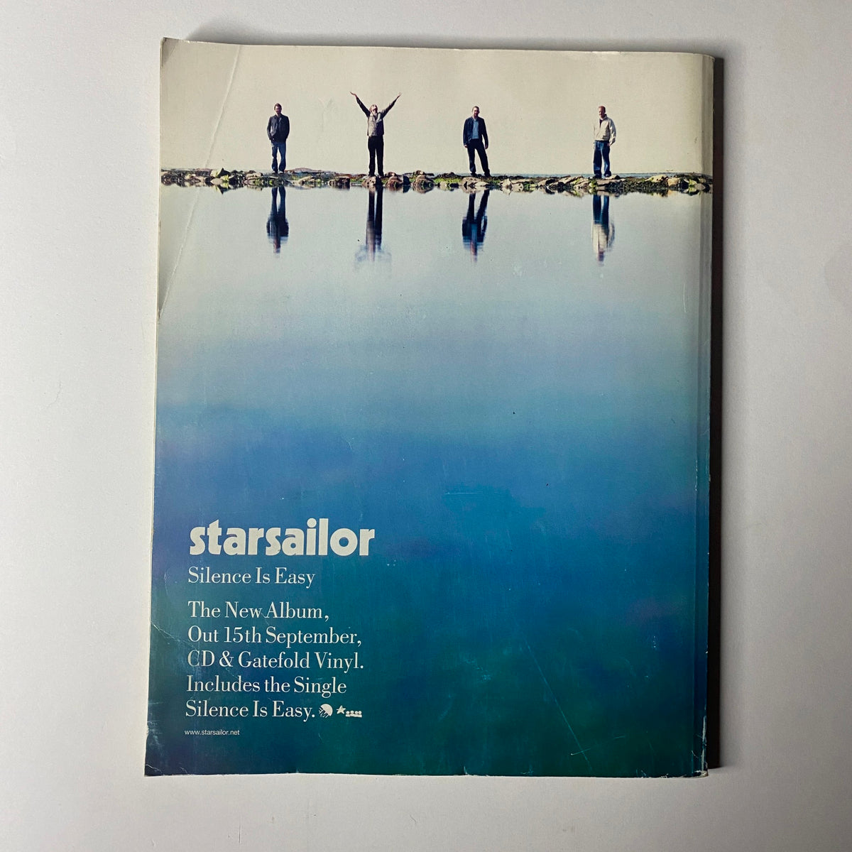 Back cover of Uncut Magazine October 2003 promoting Starsailor's album 'Silence Is Easy', featuring the band by a reflective body of water.