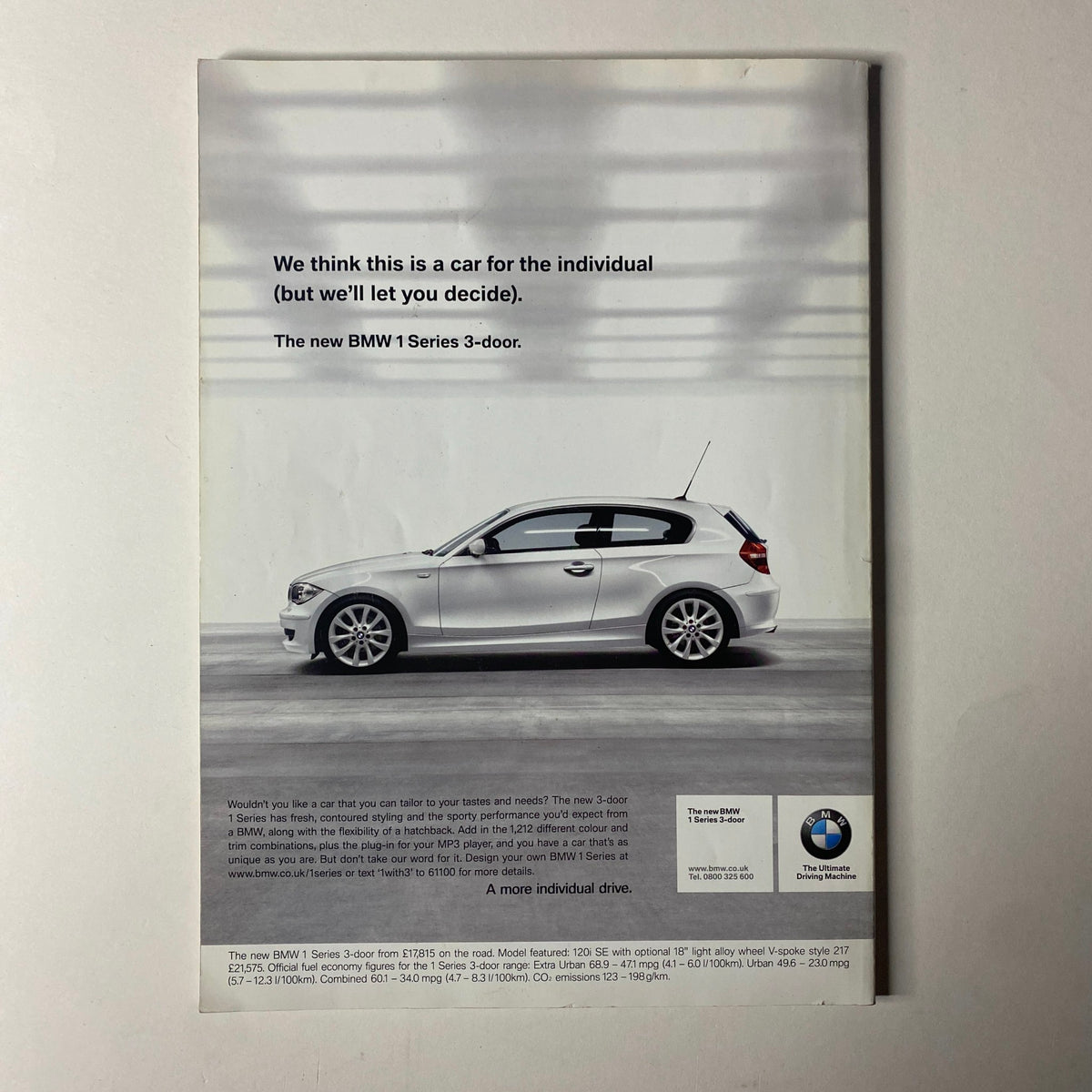 Advertisement for the BMW 1 Series 3-door, featuring a sleek white car in a minimalistic setting, promoting individuality and style.