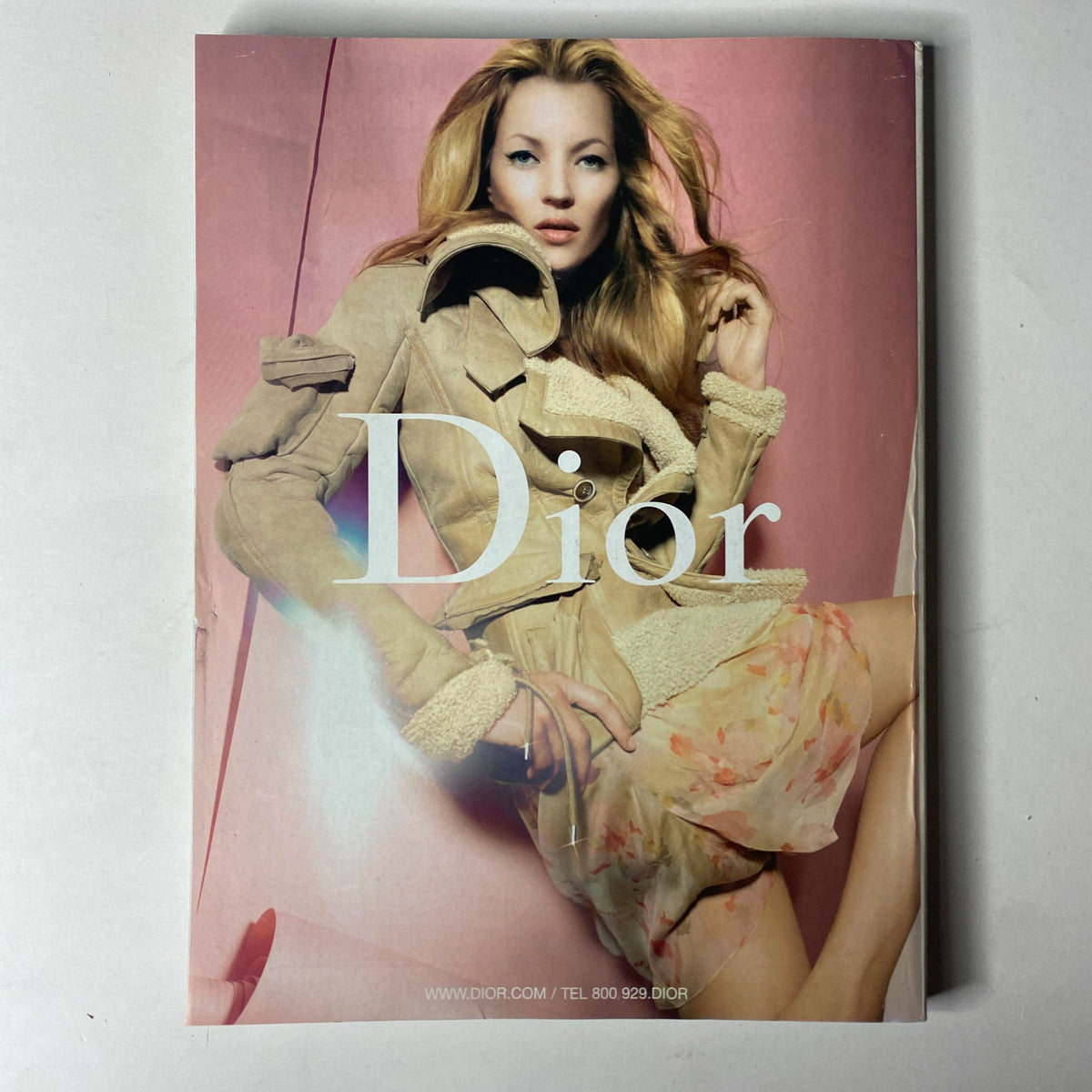 Dior fashion advertisement displaying a model in a stylish outfit on a pink background, embodying elegance and contemporary fashion as seen in the Vogue Magazine August 2005 issue.