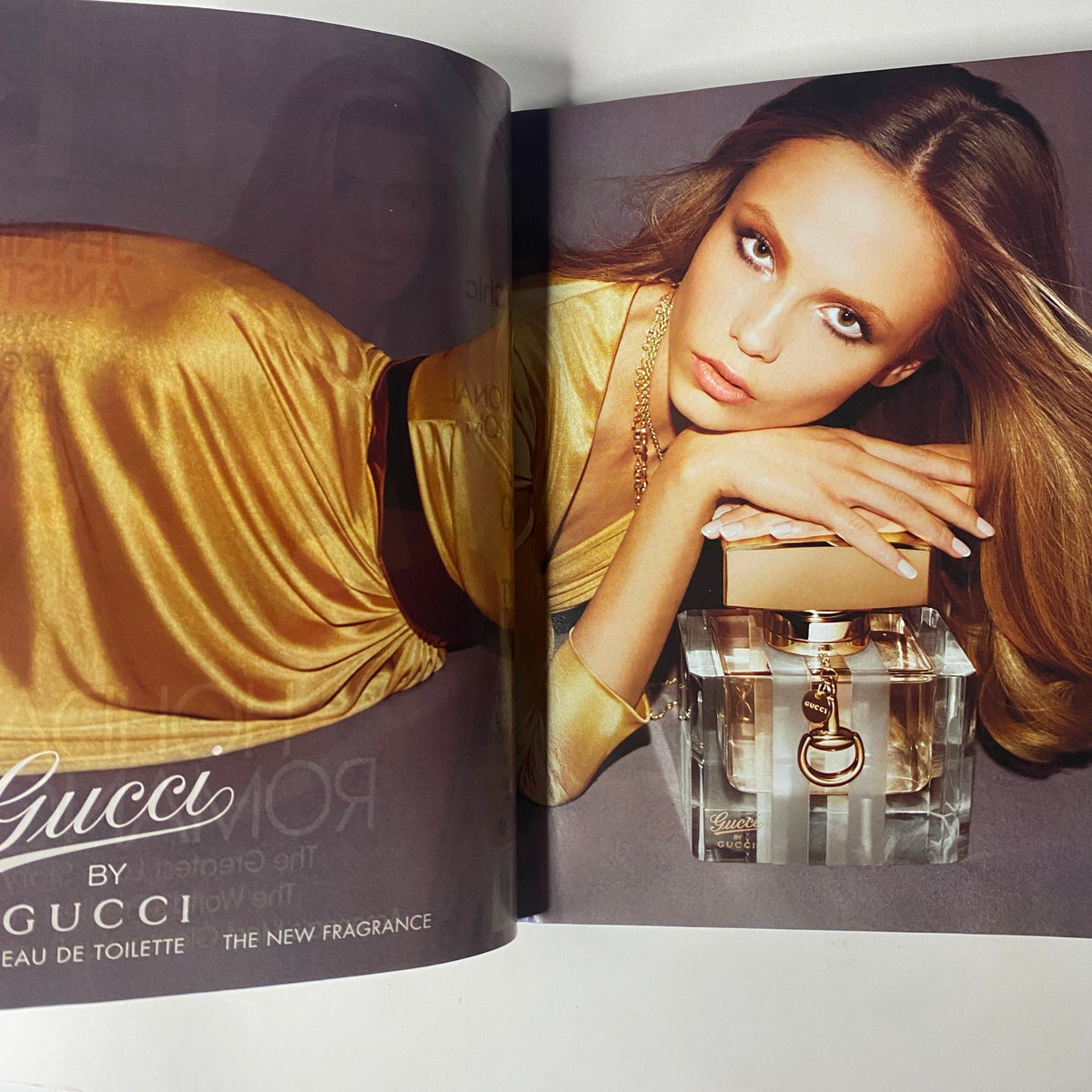 Advertisement for Gucci perfume featured in Vogue Magazine December 2008, showcasing a model wearing gold fabric and displaying the fragrance.