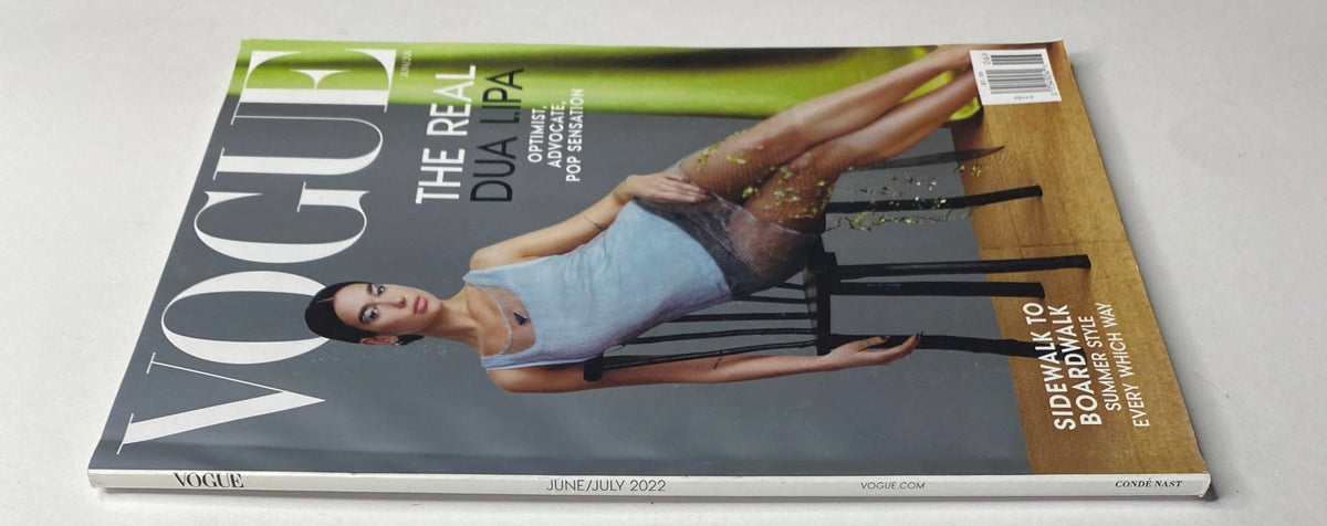 Side view of Vogue Magazine June/July 2022 showcasing Dua Lipa on the cover, emphasizing the magazine's title and vibrant color scheme.