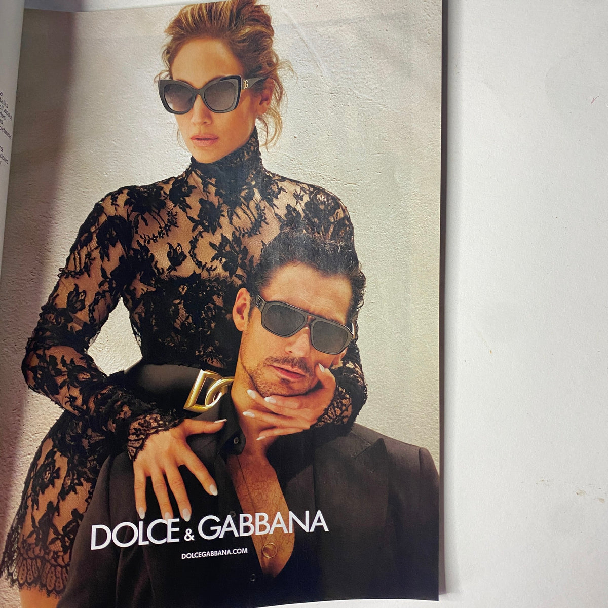 Dolce & Gabbana advertisement featuring a stylish couple in elegant attire, promoting their latest fashion collection.