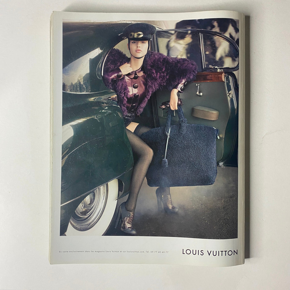 Vogue Paris Magazine September 2011 No. 920 displaying a Louis Vuitton ad with a model in vintage attire emerging from a classic car. The advertisement emphasizes luxury fashion and iconic branding in the magazine.