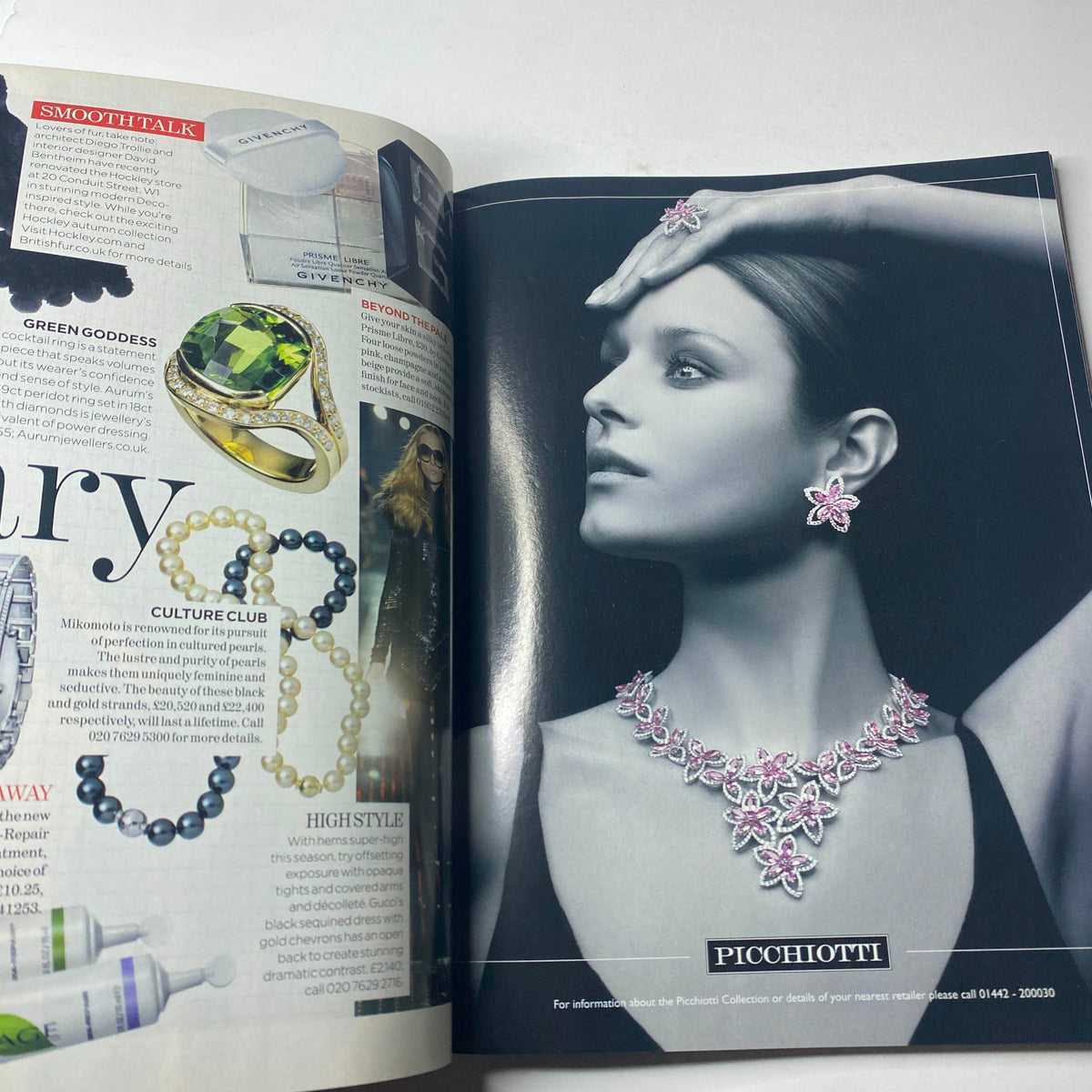 Jewelry advertisement featured in Vogue British Magazine November 2006, displaying elegant earrings and necklace worn by a model against a chic backdrop.
