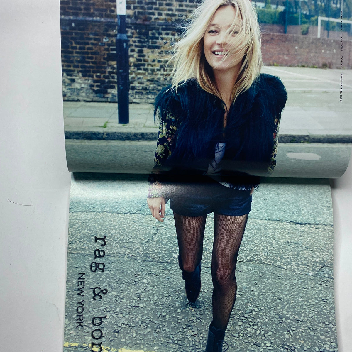 A vibrant advertisement from Vogue Paris Magazine September 2012 featuring a model wearing rag & bone fashion, capturing a lively urban aesthetic. This issue features Kate Moss on the cover.