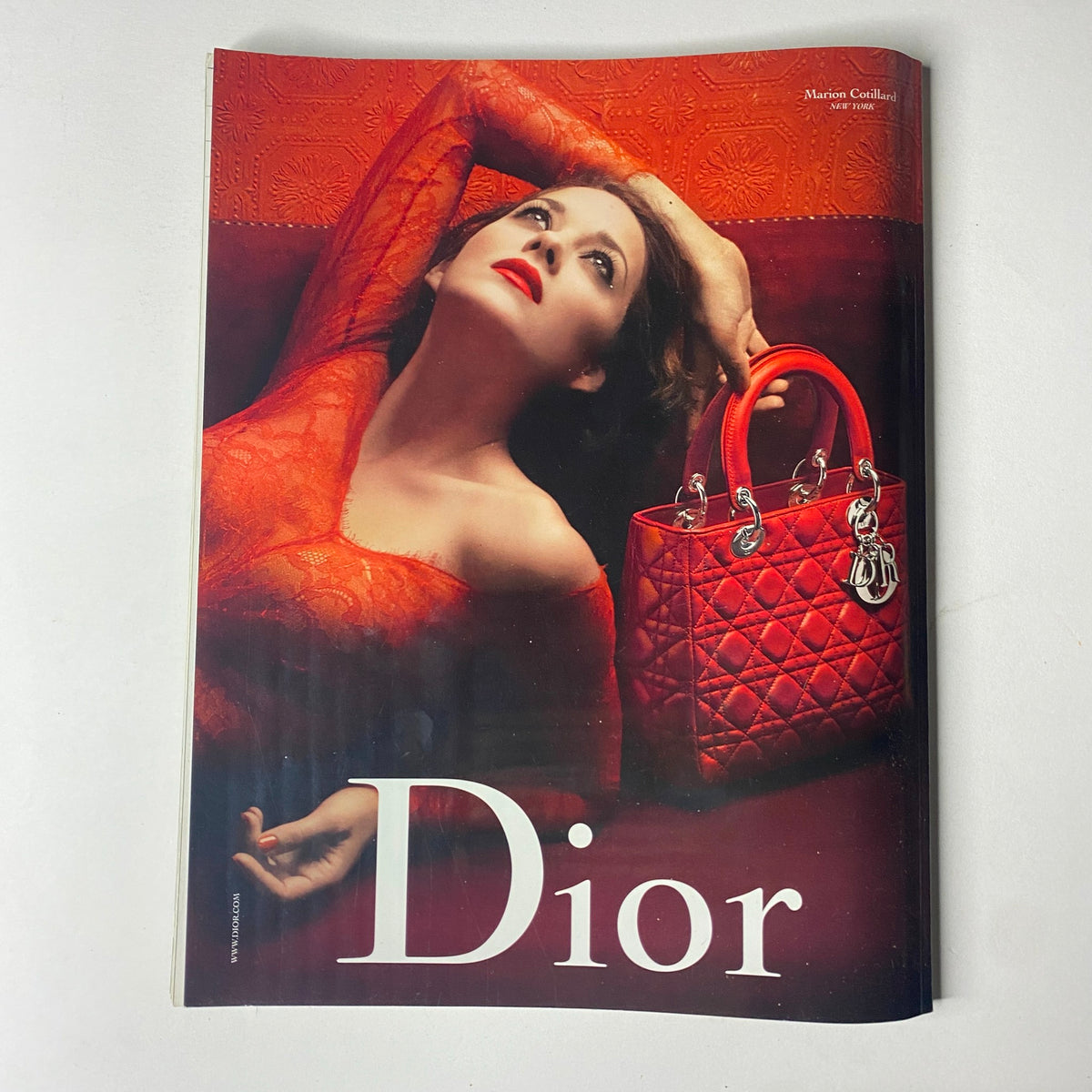 Cover image of Vogue Paris Magazine December 2009 featuring Laetitia Casta in a red outfit with a red Dior handbag, showcasing luxurious fashion photography.