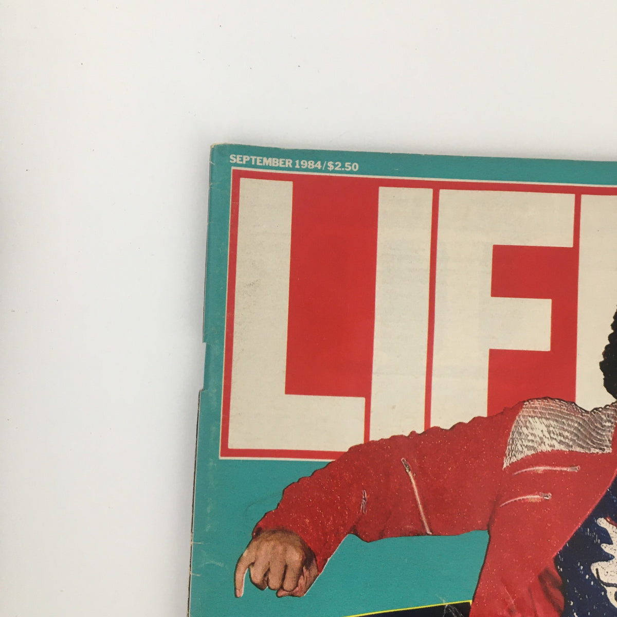 Top section of Life Magazine September 1984 cover displaying the magazine's title and date, along with a glimpse of Michael Jackson's iconic red jacket, capturing the essence of the 1980s pop culture.