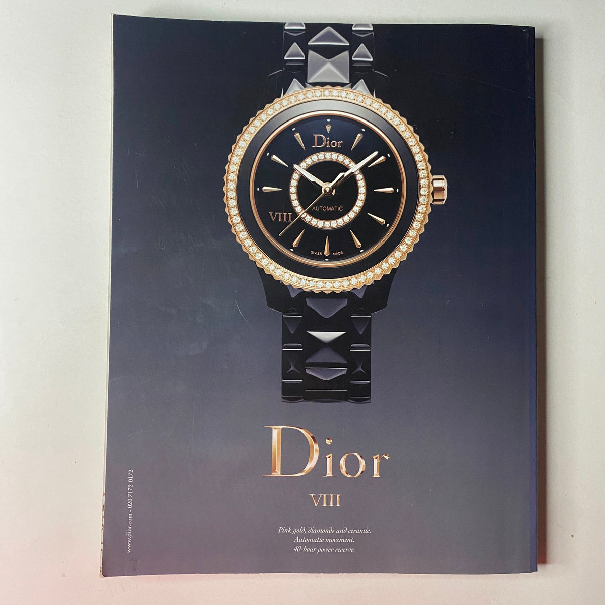 Vogue British Magazine December 2013 presenting a luxurious advertisement for Dior VIII, featuring a sophisticated timepiece with a black and gold design, encapsulating high-end fashion jewelry.