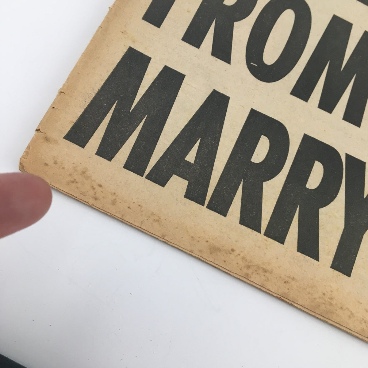 Close-up of the bottom edge of the National Enquirer Newspaper from February 6, 1966 displaying wear and aging of the newspaper.
