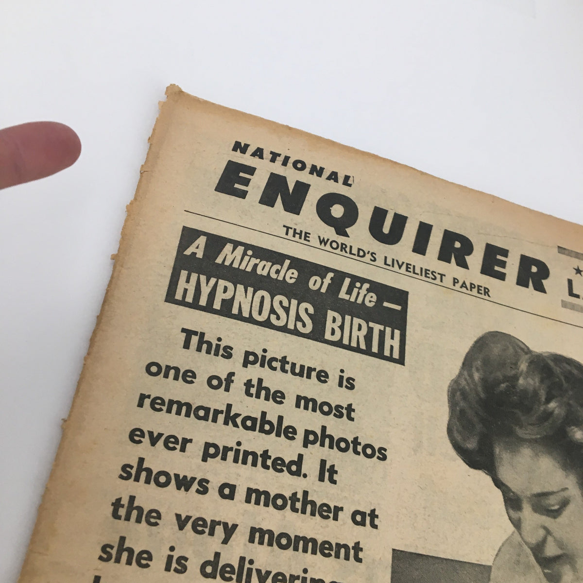 Close-up of National Enquirer Newspaper March 22 1959 headline 'A Miracle of Life - Hypnosis Birth', illustrating a significant moment in history regarding childbirth methods.