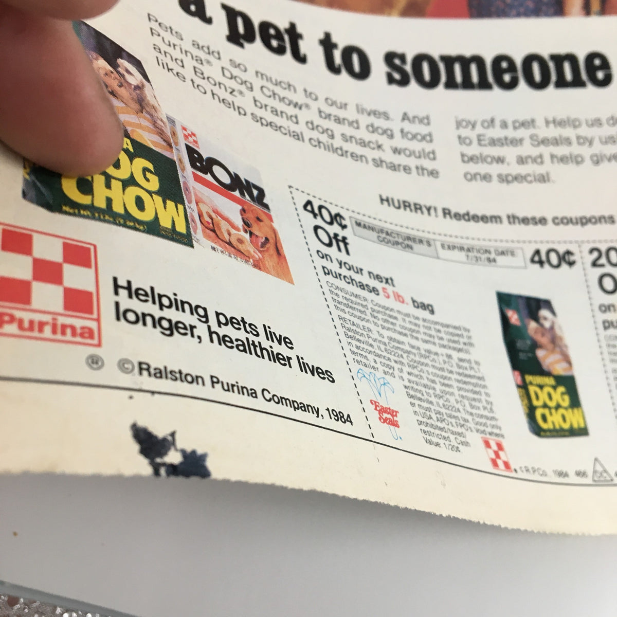 Close-up of the 1984 Purina Dog Chow Easter Seal Edition Circular Coupon Advertisement highlighting a coupon offer and the message of helping pets live longer, healthier lives.