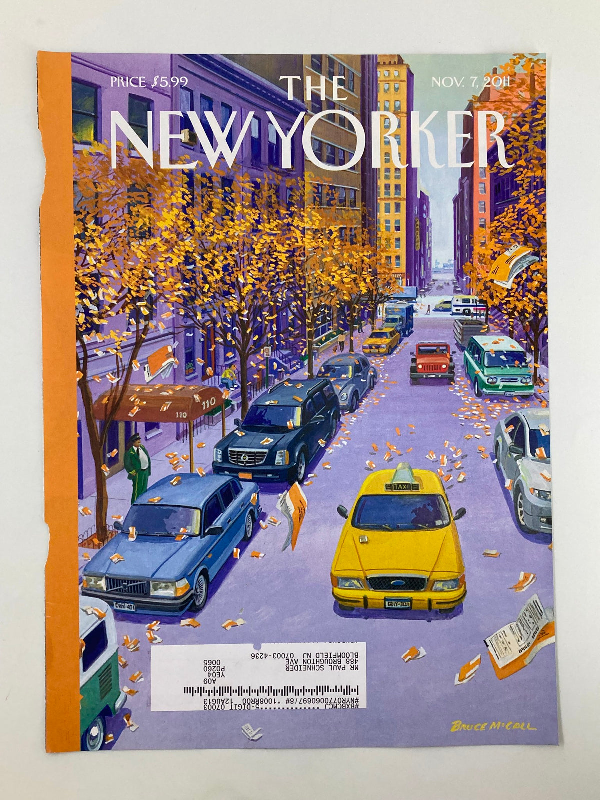 Close-up of The New Yorker November 7, 2011, cover 'Open Season' by Bruce McCall, showing an autumn street filled with vehicles amidst golden leaves.