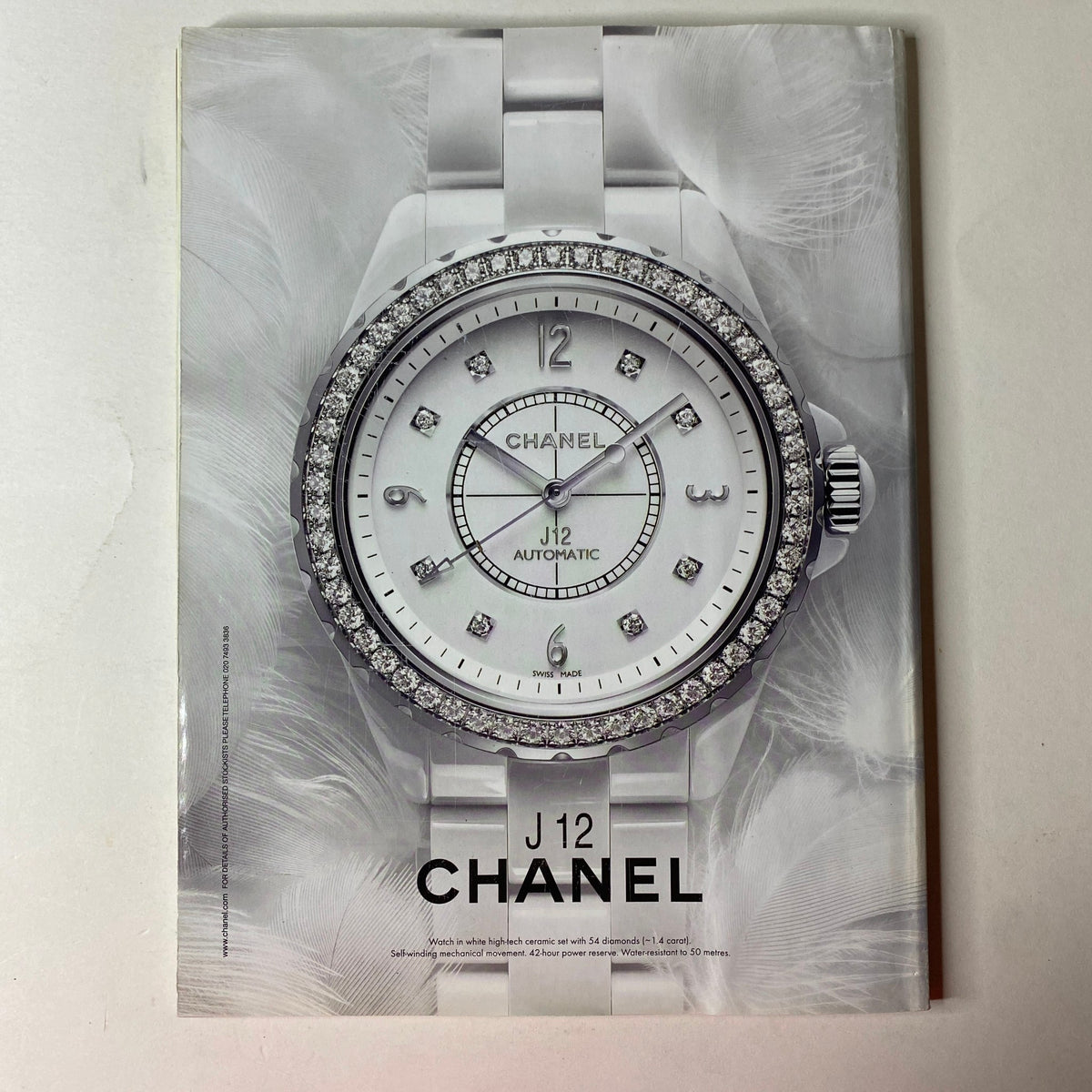 June 2012 Harper's Bazaar magazine showcasing a Chanel J12 watch advertisement, highlighting luxury and elegance in timepieces.