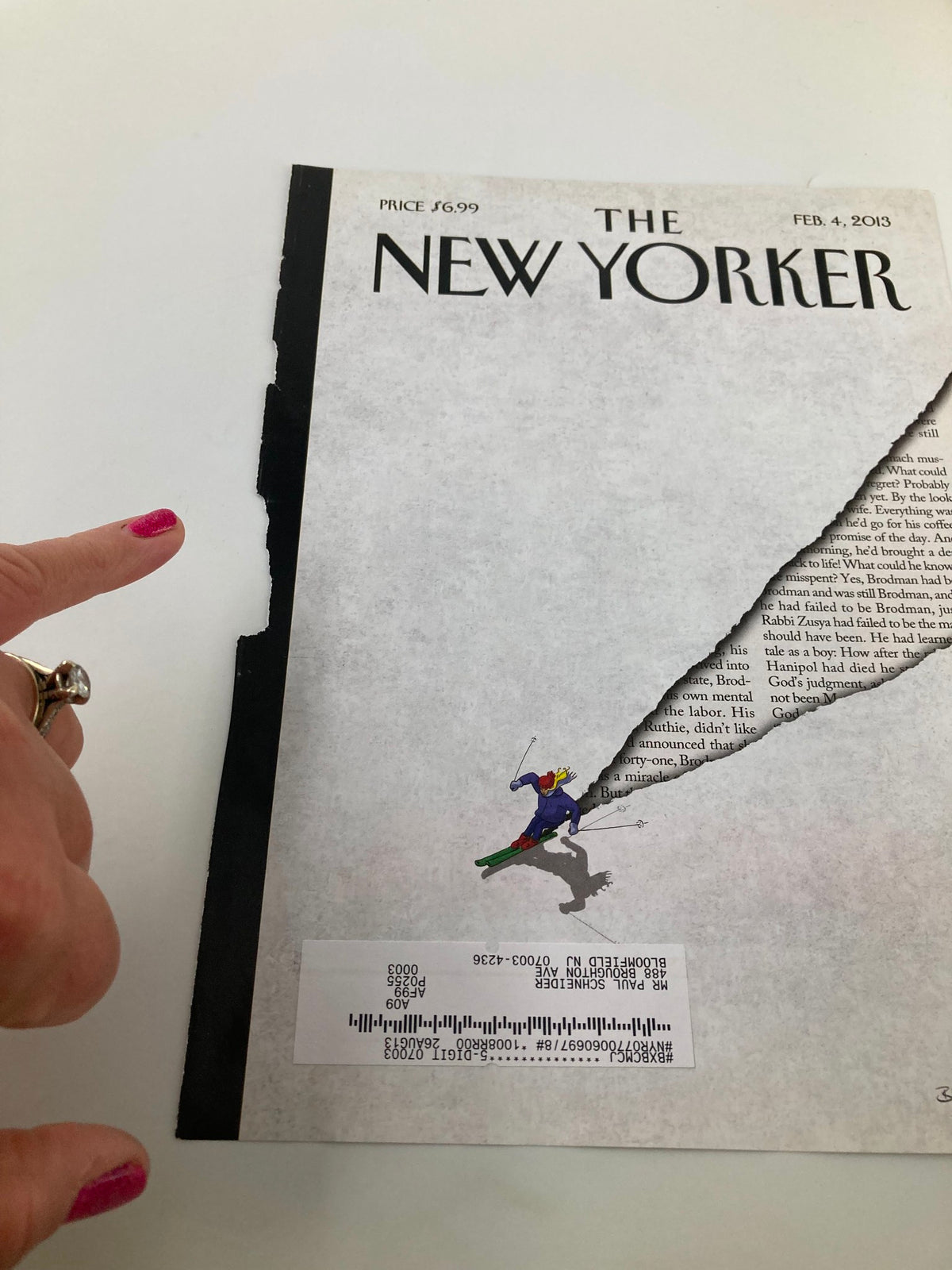 Side view of The New Yorker cover dated February 4, 2013, showcasing 'First Tracks' by Birgit Schossow, highlighting wear along the edges of the magazine.