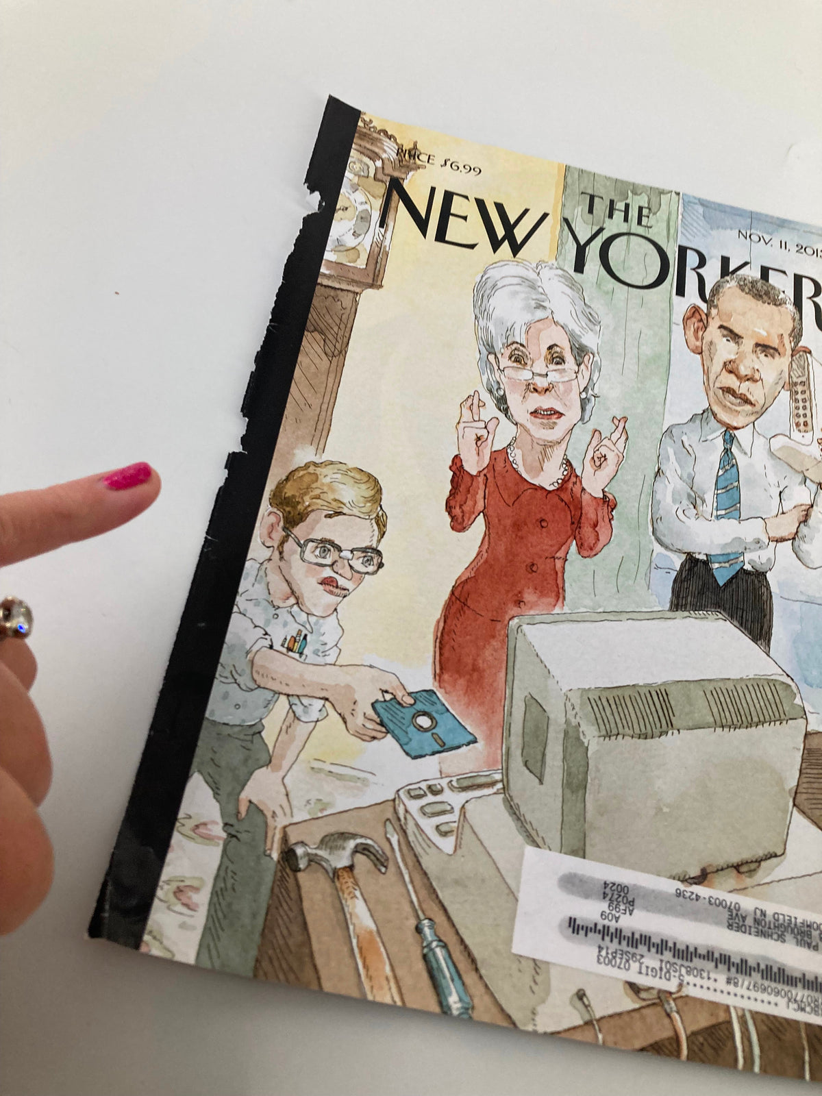 Close-up of The New Yorker November 11, 2013 cover illustrating Barack Obama and Kathleen Sebelius with unique comic art style by Barry Blitt, showcasing cultural commentary.