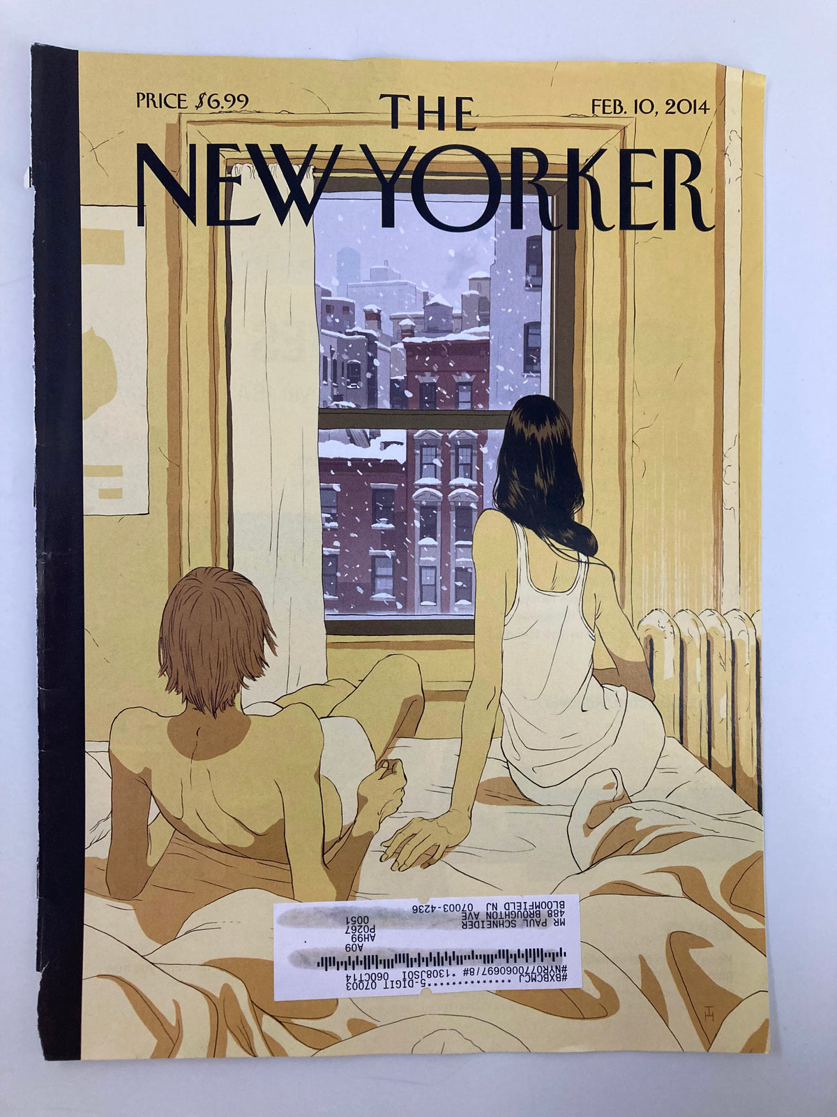Cover of The New Yorker February 10, 2014, featuring 'Perfect Storm' by Tomer Hanuka, showing a scenic snow view from a bedroom window with a couple relaxing on the bed.