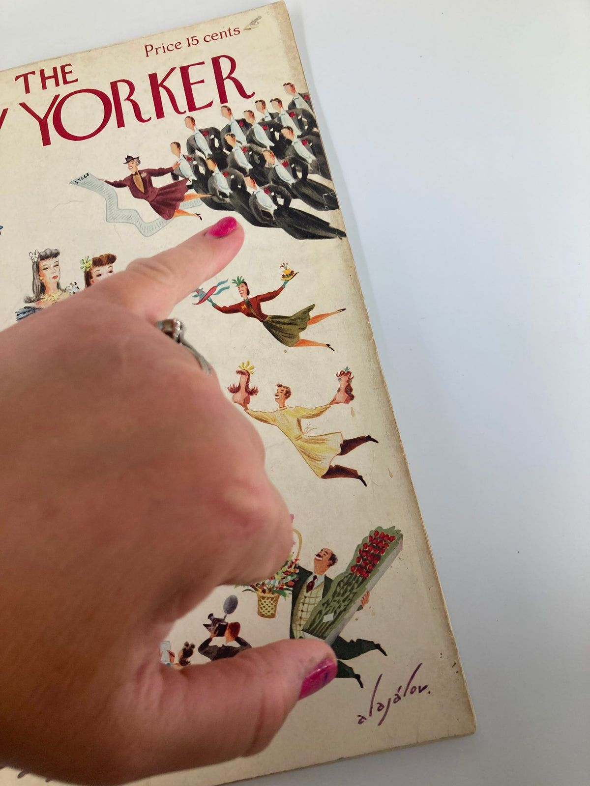 Close-up of The New Yorker Magazine January 25, 1941 cover where a hand points at the illustrations, highlighting the artistic details of 'Debutante Contest' by Constantin Alajalov.