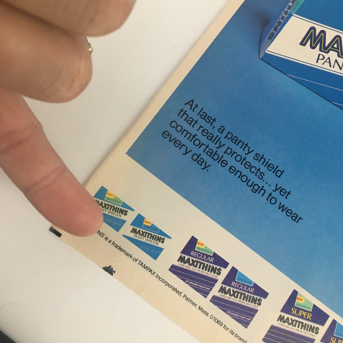 Close-up of the 1984 Maxithins Unscented Panty Shields Circular Coupon Advertisement highlighting brand logos and product details, illustrating features of Maxithins panty shields.