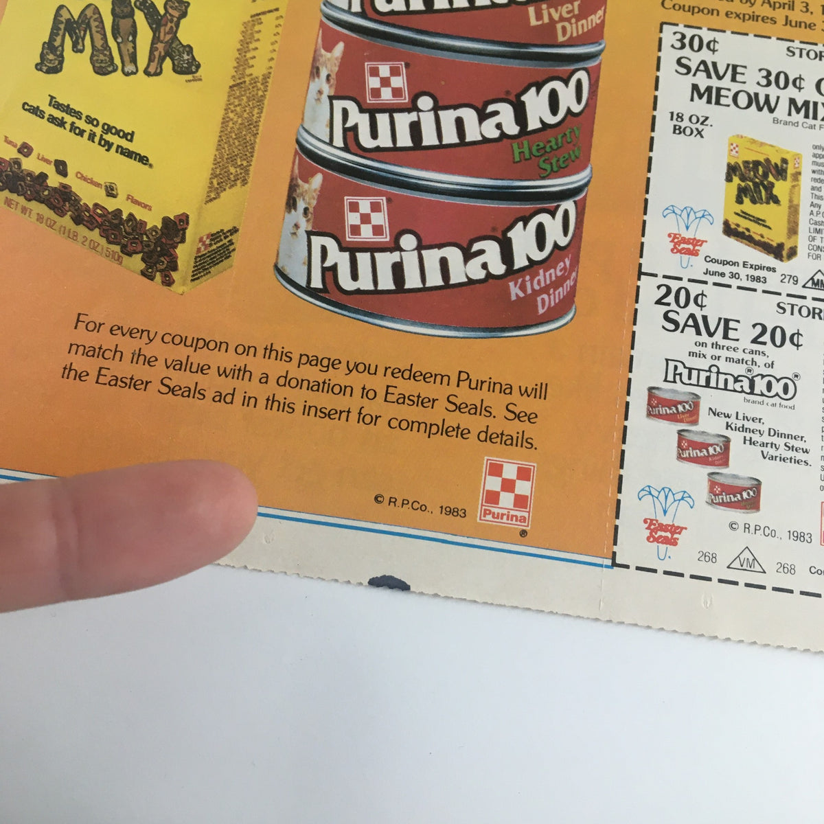 Close-up view of Purina 100 cat food options, part of the 1983 Purina 00 Liver Dinner Cat Foods Circular Coupon Advertisement, illustrating various canned cat food products.