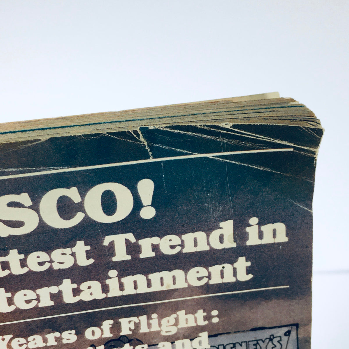 Close-up of the top edge of the Vintage Life Magazine from November 1978, featuring text about the entertainment trends of the era, highlighting Walt Disney's Mickey Mouse on the cover.