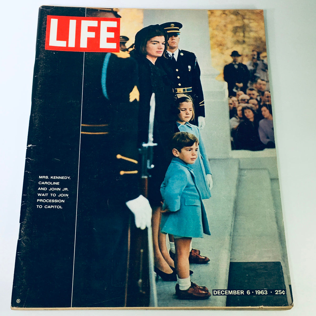 Vintage Life Magazine cover from December 6, 1963, featuring Mrs. Kennedy alongside her children Caroline and John Jr. waiting to join a procession to the Capitol.