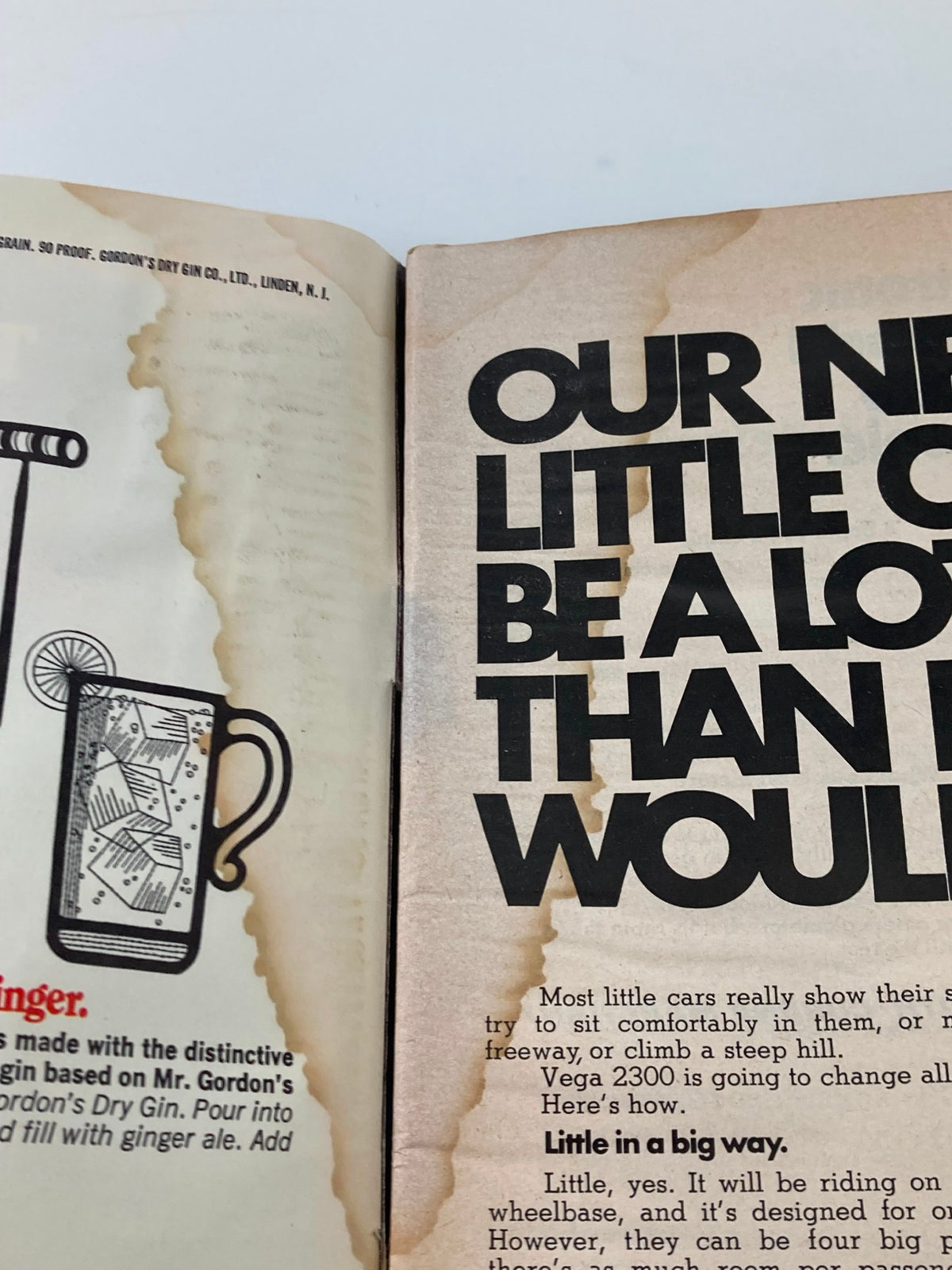Interior pages of the Sports Illustrated magazine from June 22, 1970, featuring an advertisement with a faded background and prominent text stating 'OUR NEW LITTLE CAR.' The page depicts vintage-style graphics from the era.