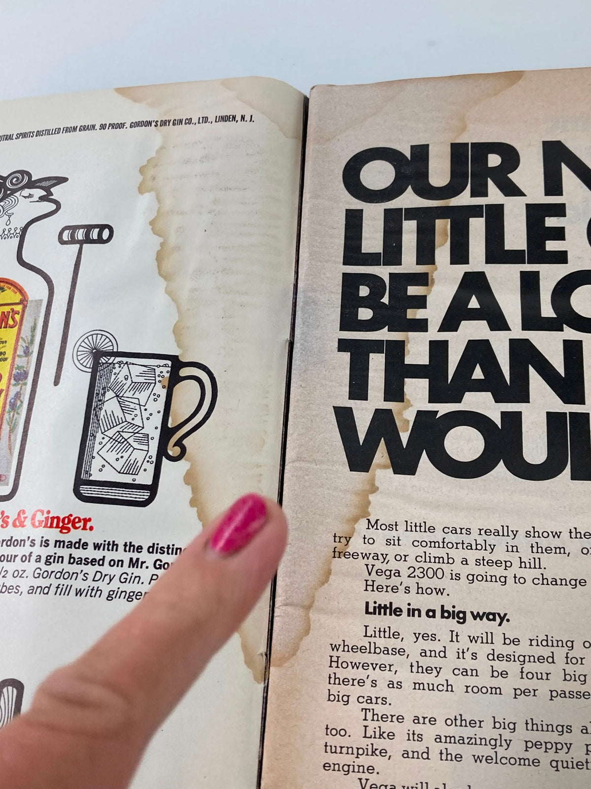 Another interior view of the Sports Illustrated magazine, dated June 22, 1970, showcasing an advertisement discussing a new car model. The image highlights the worn pages with significant age marks and a finger pointing at the text.