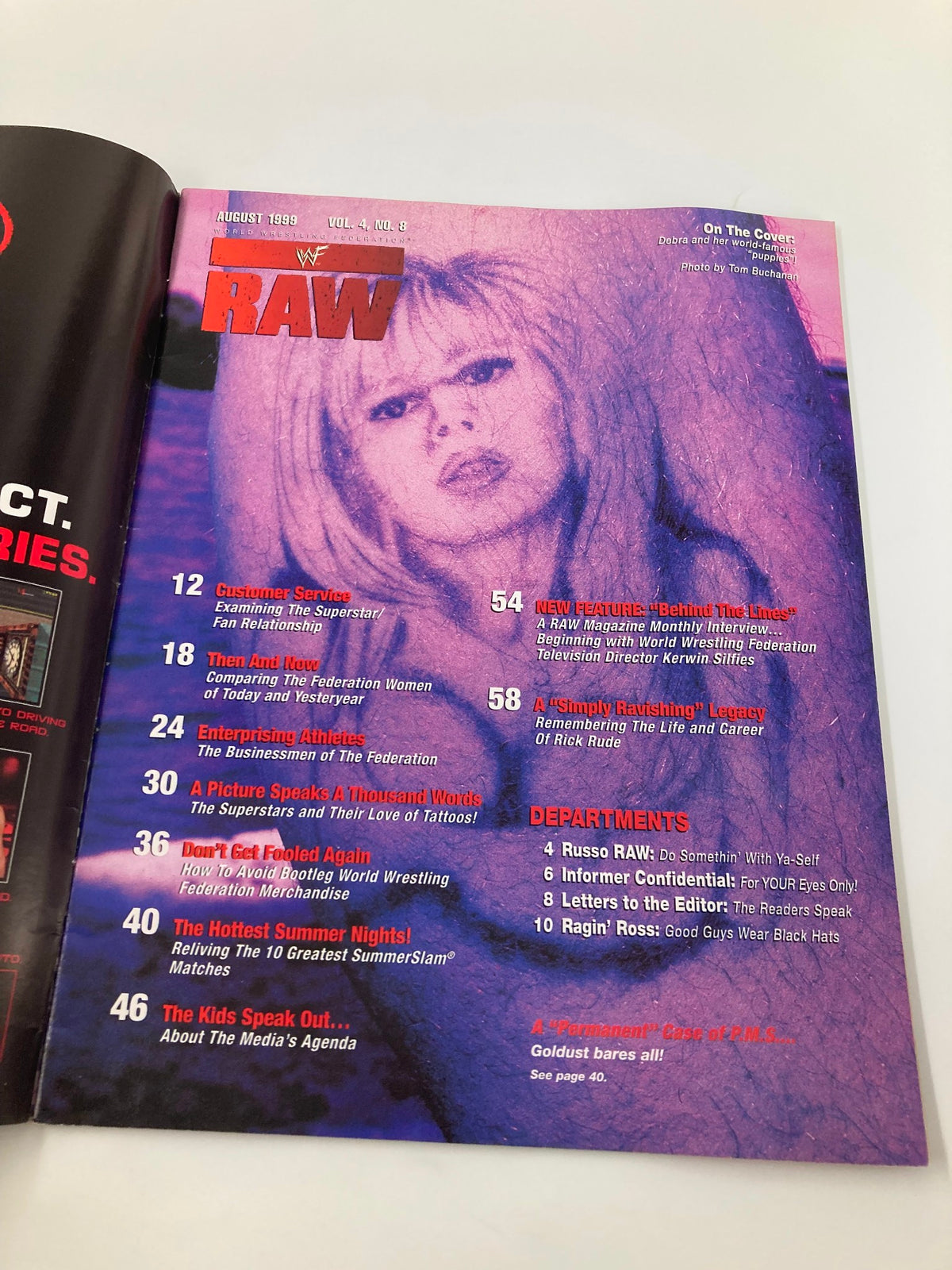 WWF Raw Magazine August 1999 cover featuring Debra and her world-famous 'Puppies'. The vibrant magazine showcases a striking pink and purple design, reflecting the wrestling culture of the late 1990s.