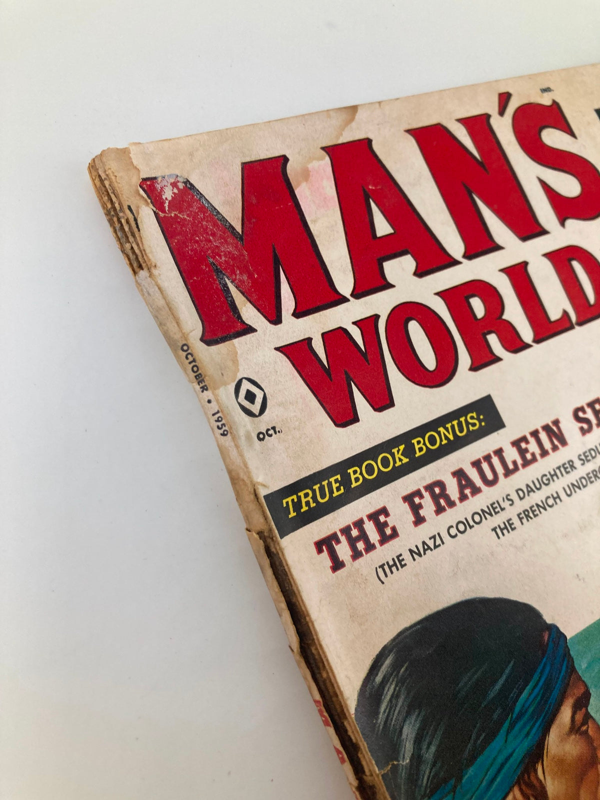 Detail of the spine and cover of VTG Man's World Magazine October 1959 showcasing the vintage condition and title 'The Fraulein Sellout'.