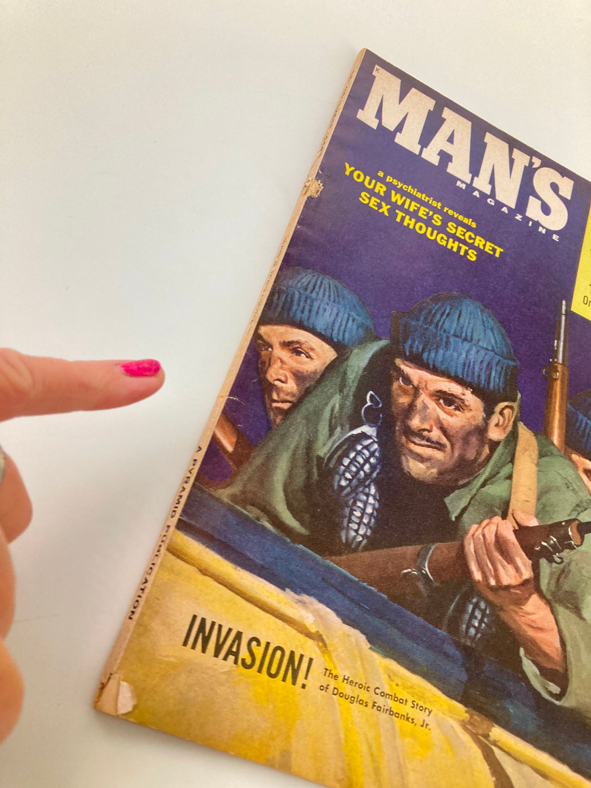 Close-up of the VTG Man's Magazine November 1958 cover, showcasing a pointed finger toward the dramatic illustration and text. The cover emphasizes the heroic combat story of Douglas Fairbanks Jr. alongside other provocative headlines.