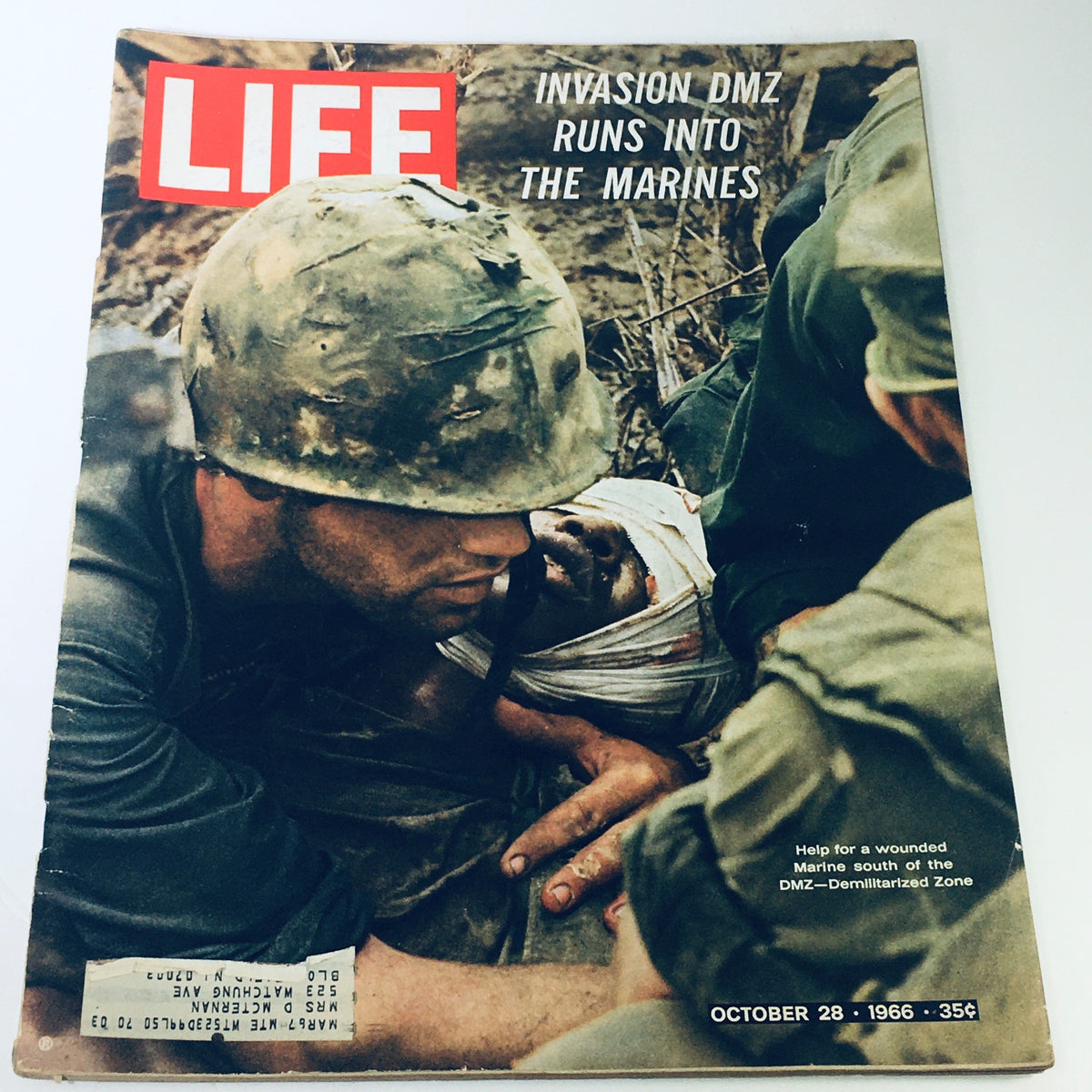 Vintage Life Magazine cover from October 28, 1966, titled 'Invasion: DMZ Runs Into The Marines.' The cover features U.S. Marines assisting a wounded soldier during the Vietnam War.