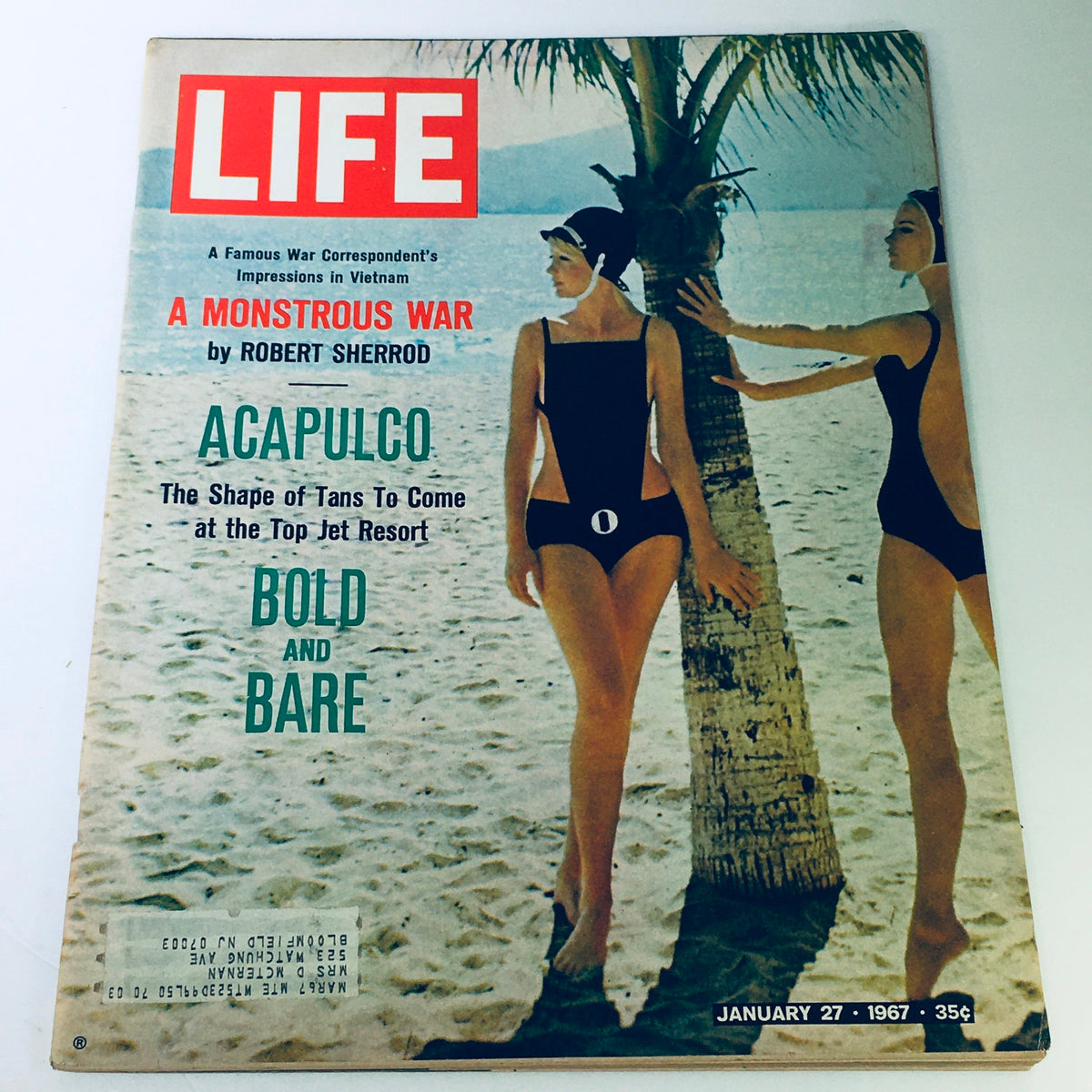 Cover of Life Magazine from January 27, 1967 featuring the title 'A Monstrous War' by Robert Sherrod, with an image of two women in vintage swimwear on a beach in Acapulco, showcasing 1960s fashion and culture.