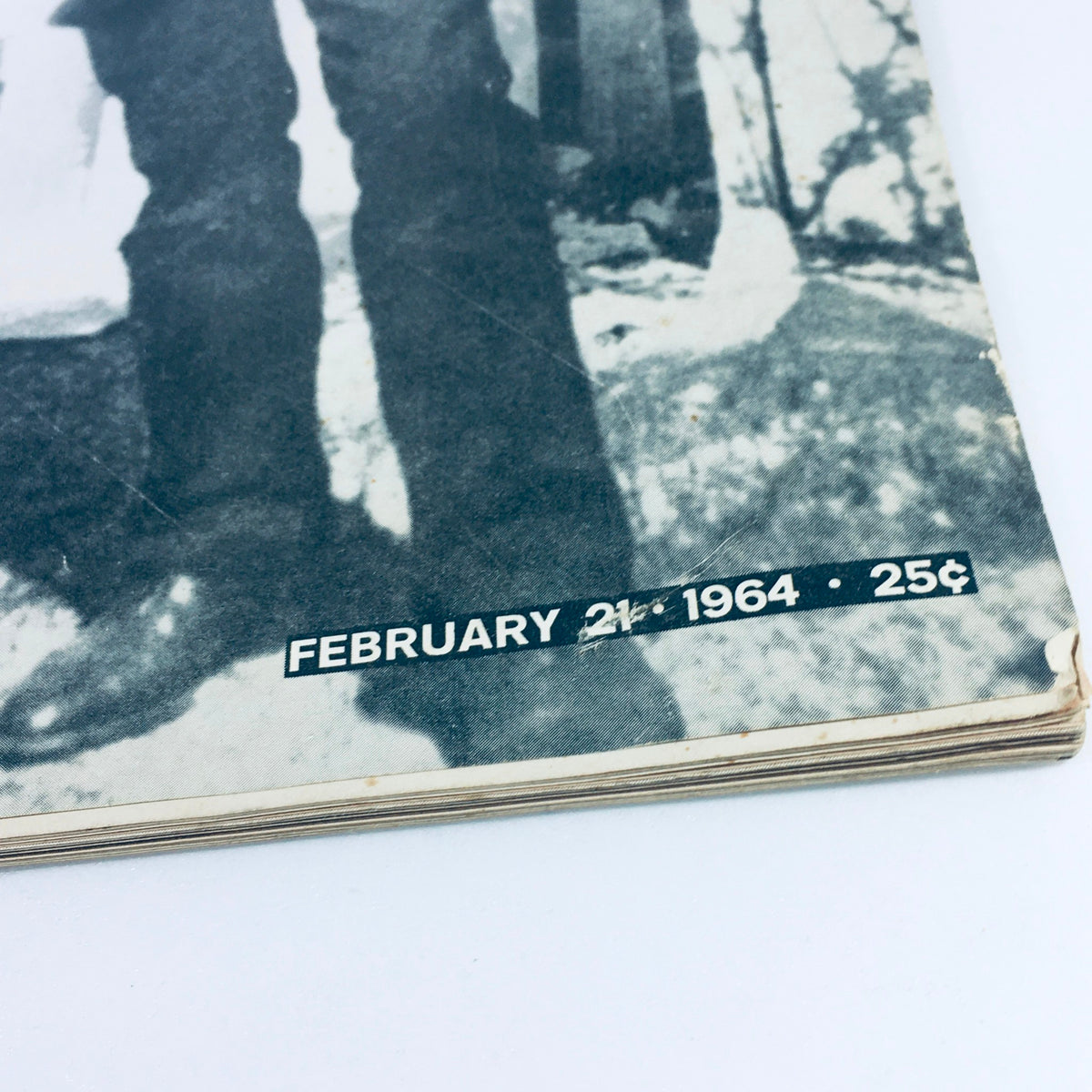 Close-up view of the bottom corner of the VTG Life Magazine February 21 1964, highlighting the date and price, featuring historical content about Lee Oswald and the assassination of President Kennedy.